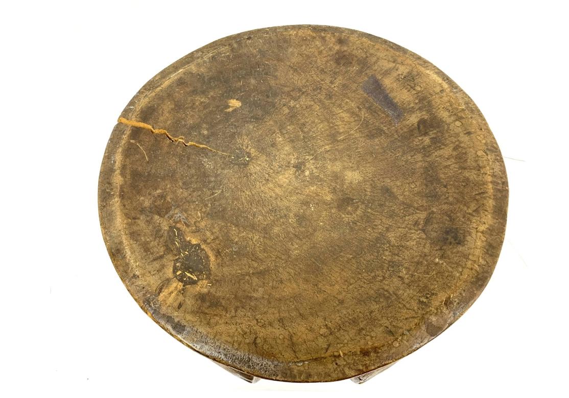 A strongly carved African stool with sculptural appeal. With good traditional form having a central pillar and scooped seat with a beveled edge. All original condition with age split on seat and base. 

Dimensions: 13.75” diameter by 13” high.