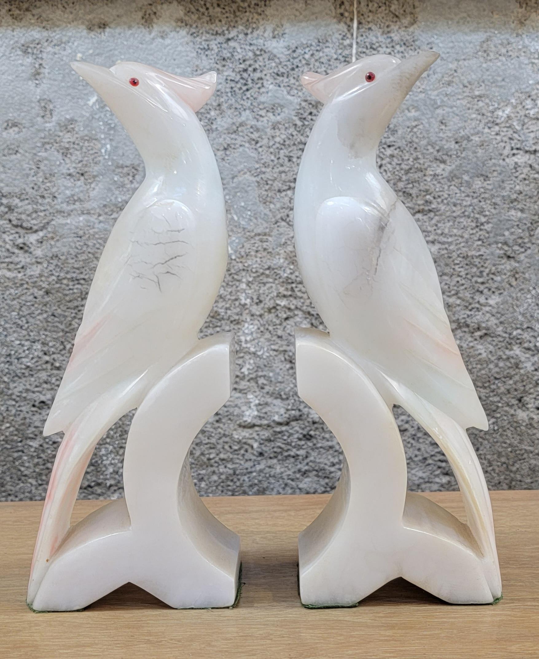A pair of carved alabaster Cockatoo bird bookends. White, black and pink marbleized alabaster. Each bookend measures 9.5 inches tall, 3.75 inches wide, 2.25 inches deep.