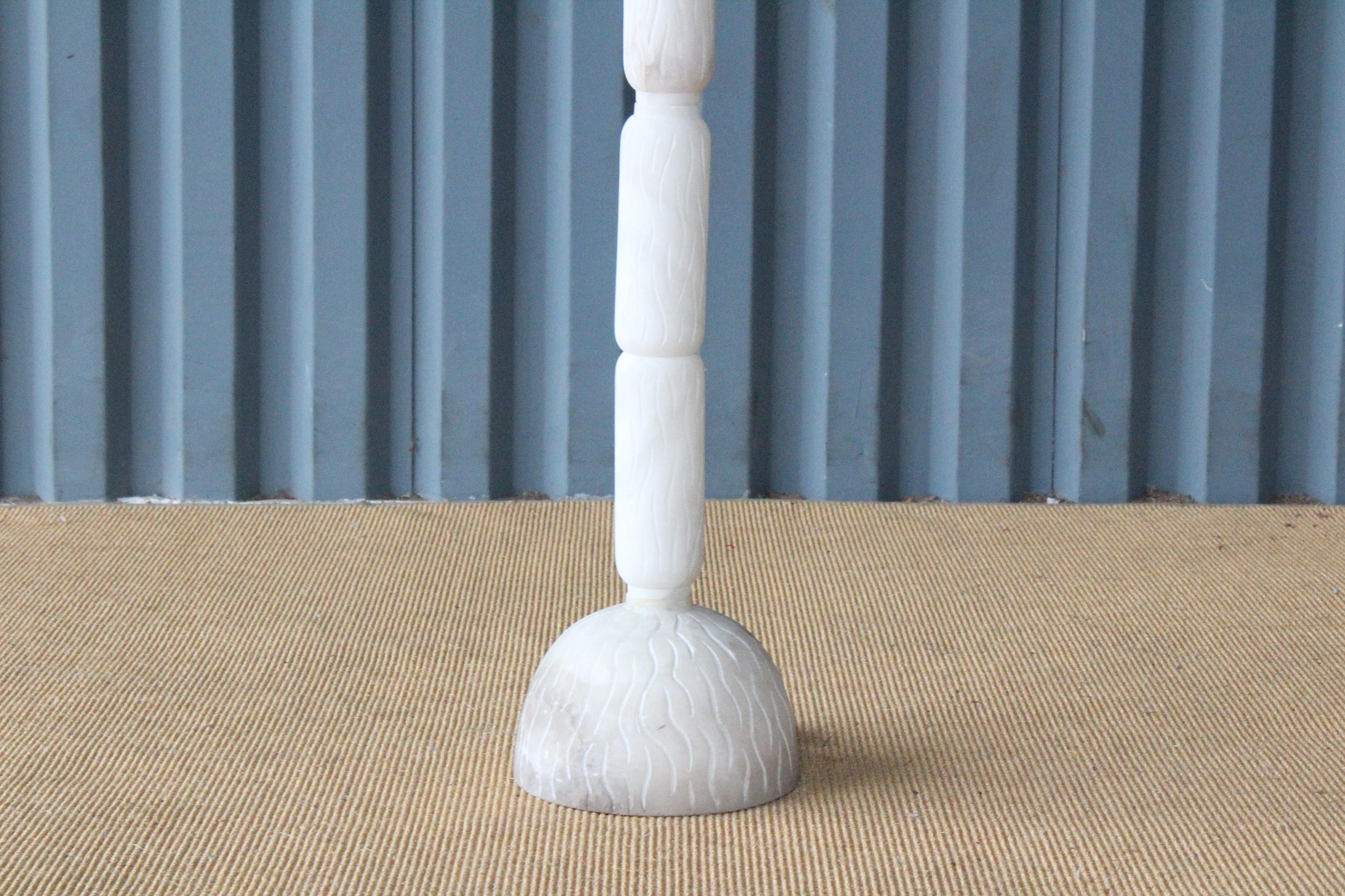 Carved alabaster 1970s Italian floor lamp. Recently rewired and fitted with a custom shade in linen. Note: floor lamp leans slightly.