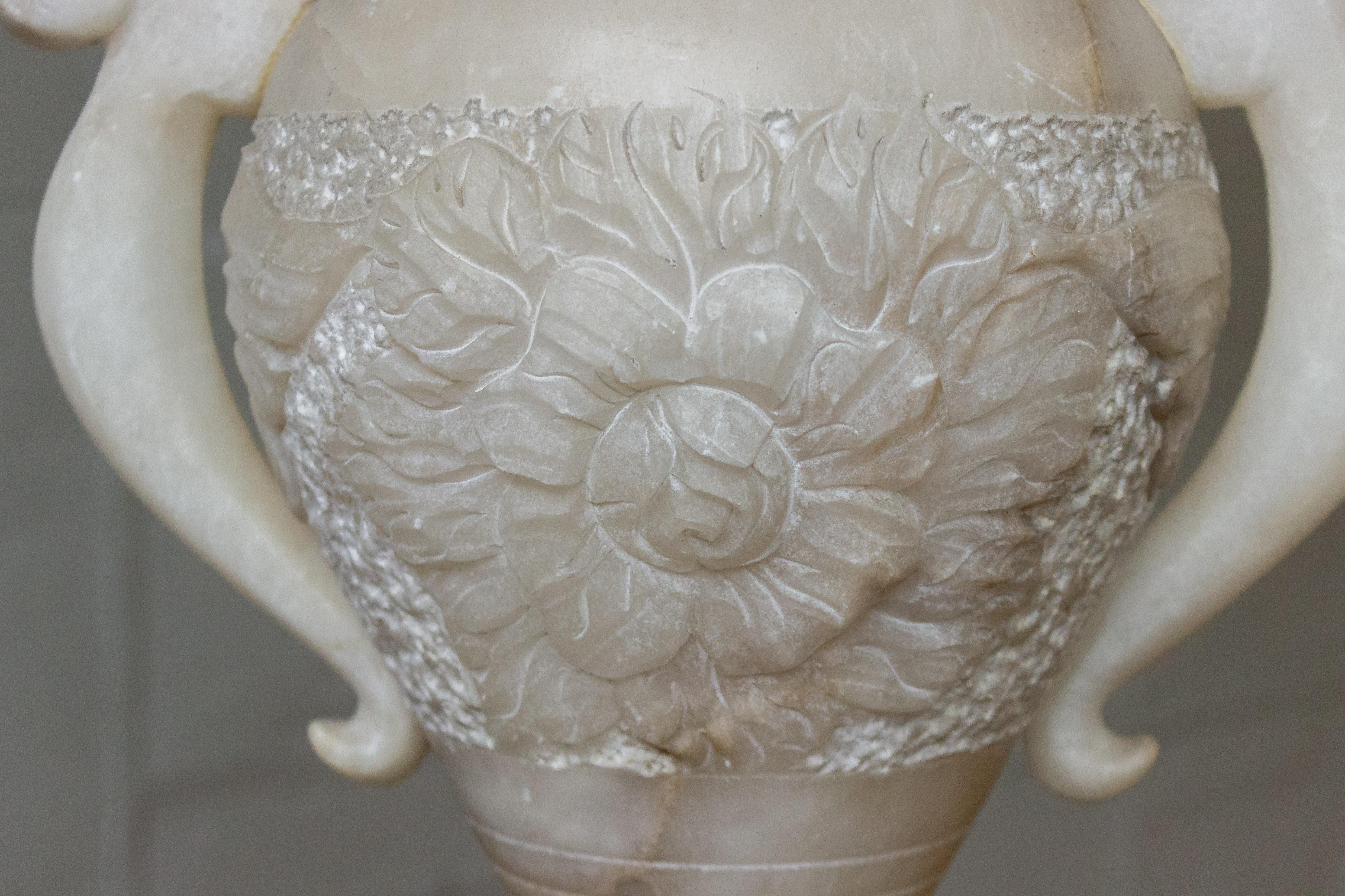Carved Alabaster table lamp with floral motif and carved handles. Wired for use with single candelabra bulb.


 