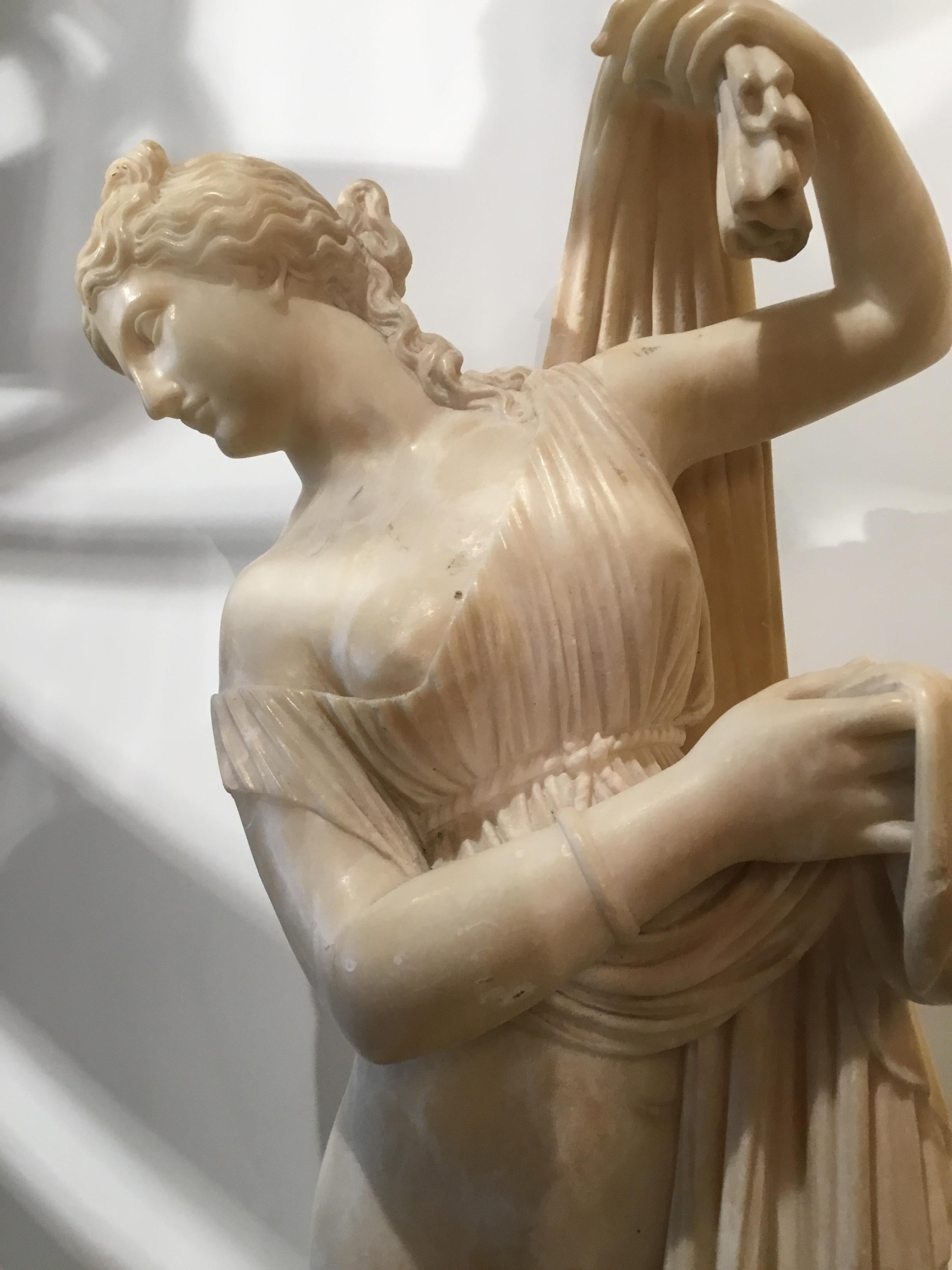 Female statue with graceful draping sculpted in alabaster. The goddess
In her maternal aspect, incised signature and inscribed “E. Battiglia,
Sculptore, Firenze” along edge.
 