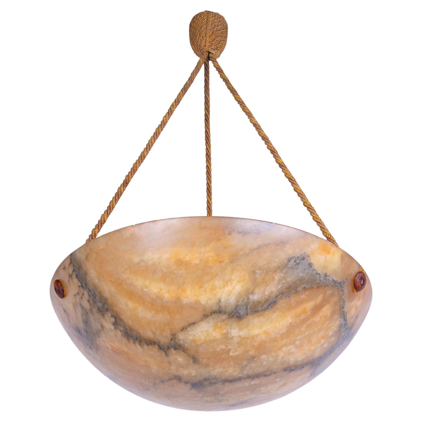 Antique carved Alabaster Art Deco ceiling light with the original, hand-knotted rope. The pendant spreads a fantastic ambient light. An absolute eye-catcher even when unlit. 

Materials: Alabaster. 
Measures: diameter 15.75