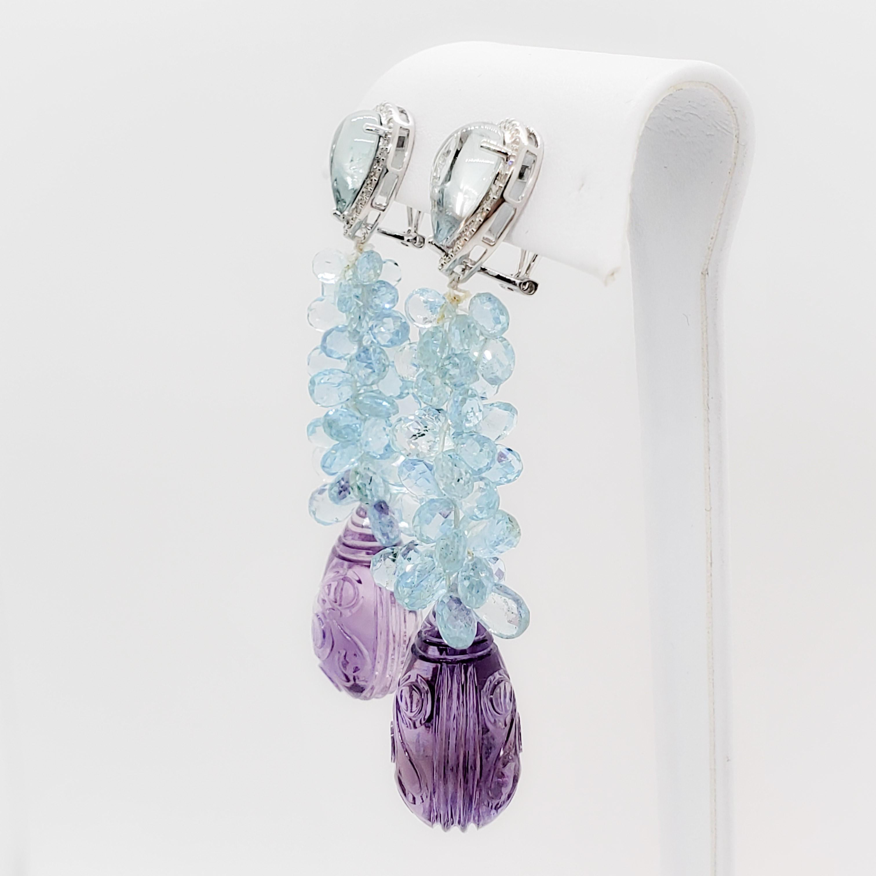Beautiful estate earrings featuring 75 cts of carved deep purple amethyst drops and 40 cts of bright blue aquamarine briolettes and cabochons in a handmade 18k white gold mounting.  Approximate 0.25 cts of good quality white diamond rounds. 