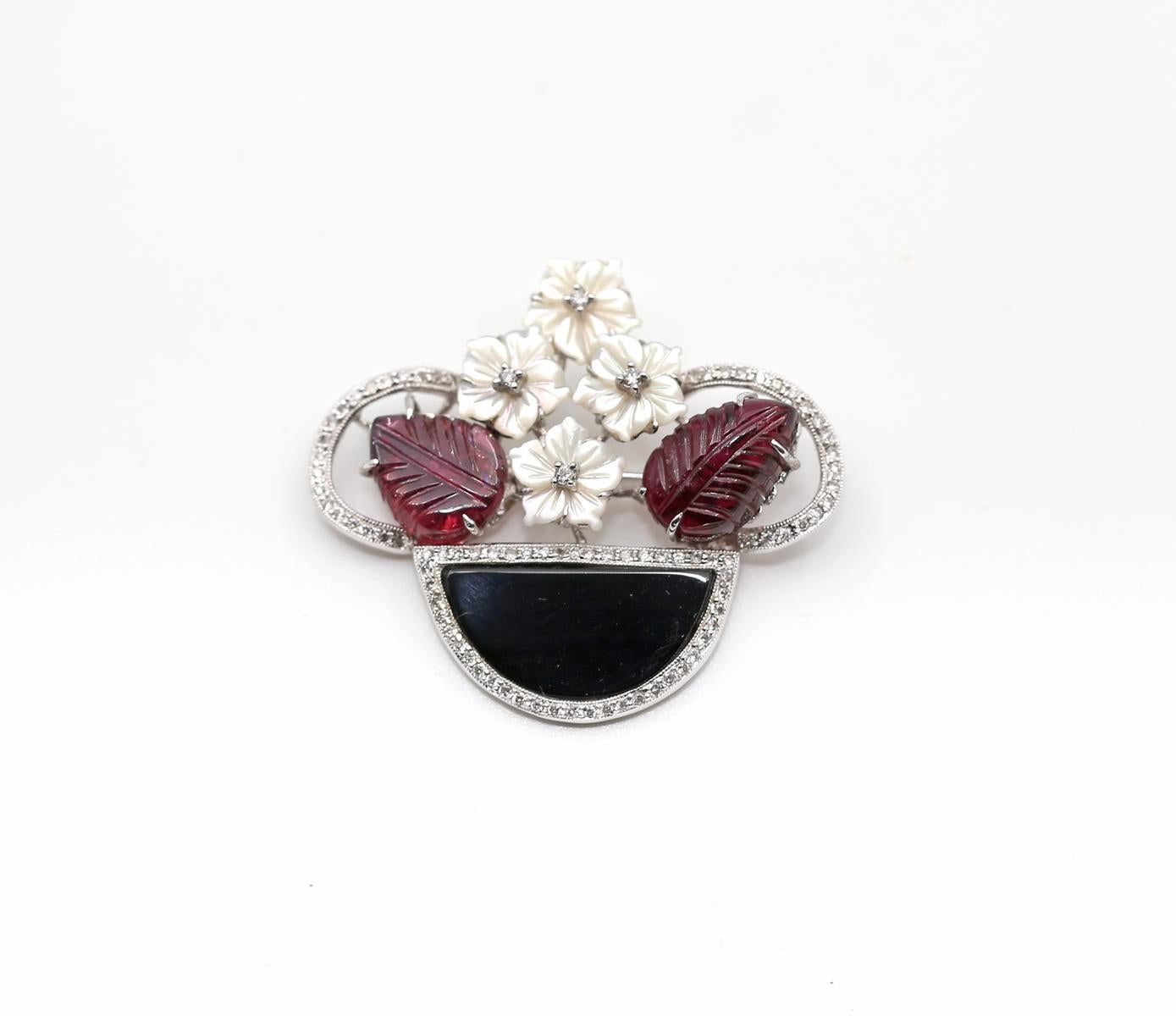 Diamonds Carved Amethyst Onyx Mother-of-pearl Flower Brooch 18K Gold. 
A Diamond and Gem-set brooch. Designed as a carved Mother-of-pearl and Amethyst floral spray, with an Onyx and brilliant-cut Diamond basket. Total Diamond weight 0.40Ct, stamped