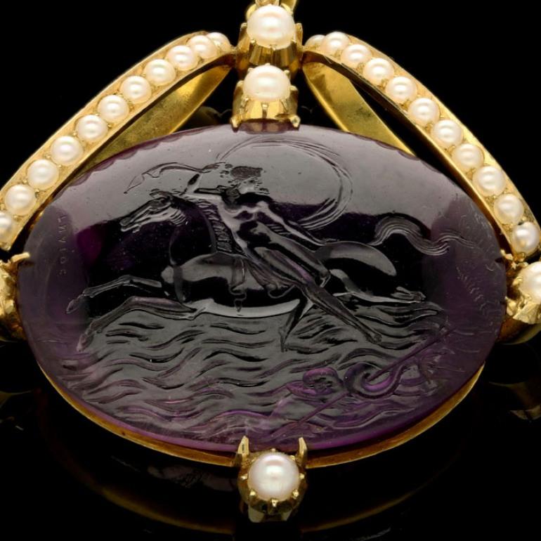 Oval amethyst intaglio 38mm x 30mm
31 cream round half pearls
5.9cm long, 4.7cm wide
30 grams

A Neoclassical amethyst intaglio pendant c.1820 from The Poniatowski Collection, the oval amethyst engraved with a scene from Classical mythology