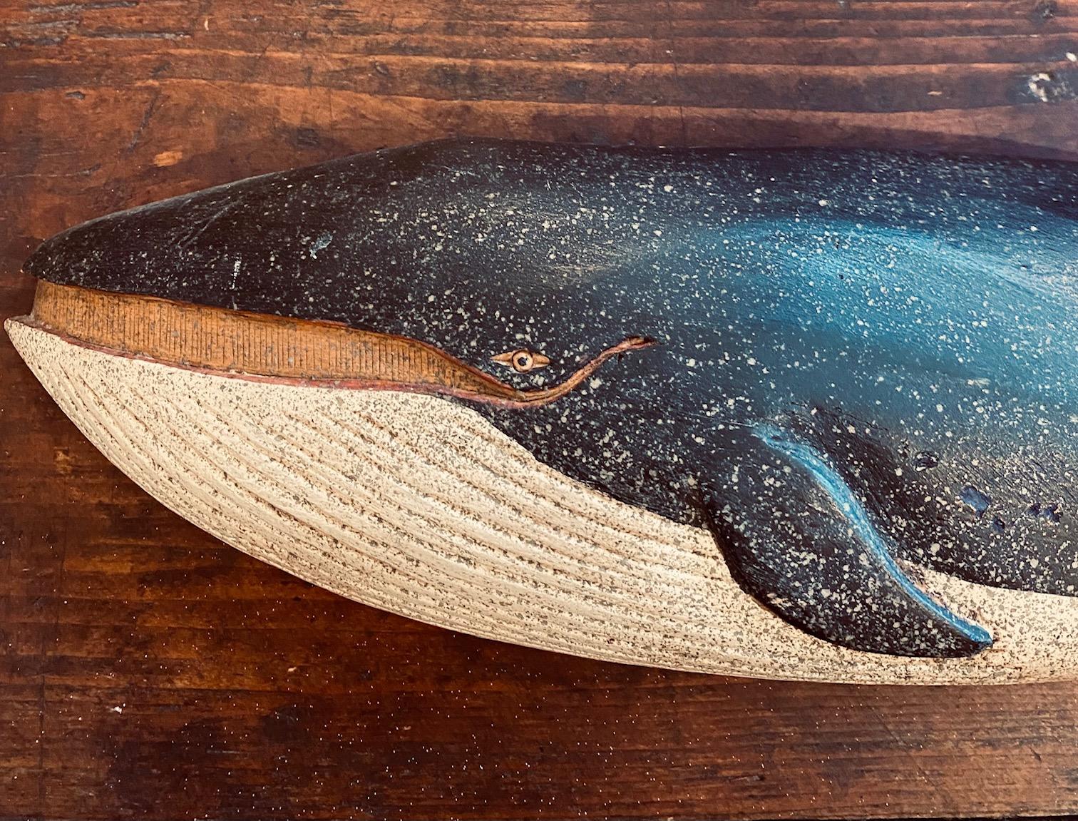 Carved and decorated finback whale plaque by Clark Voorhees (1911 - 1980), circa 1960, carved quarter round figure of a whale in fine original painted surface, signed by stamp on the reverse.

Measures: 4-1/4 in H x 18-1/2 in L x 2-1/8 in Deep.
