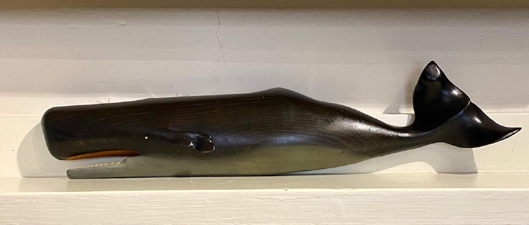 Vintage carved and polychromed wooden sperm whale by M. Gracie, South Dartmouth, MA, 1976, a skillfully carved sperm whale half-plaque, with open mouth exposing the lower jaw of teeth, and very gracefully curled flukes on the tail, signed and dated