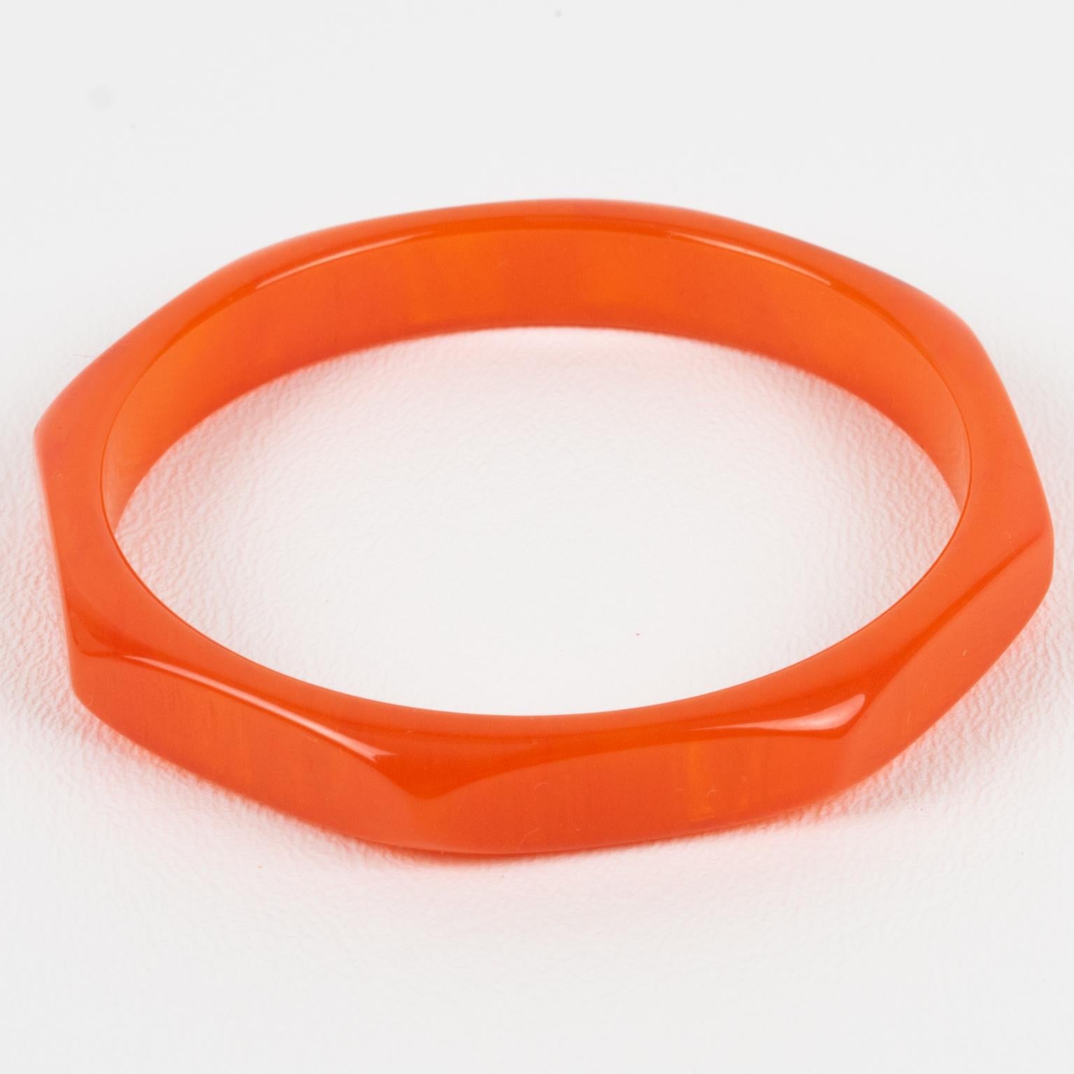 This superb neon orange marble Bakelite bracelet bangle has a chunky octagonal spacer shape with a deeply faceted and carved design. It features an intense bright orange marble color with translucent swirling.
Measurements: Inside across is 2.50 in