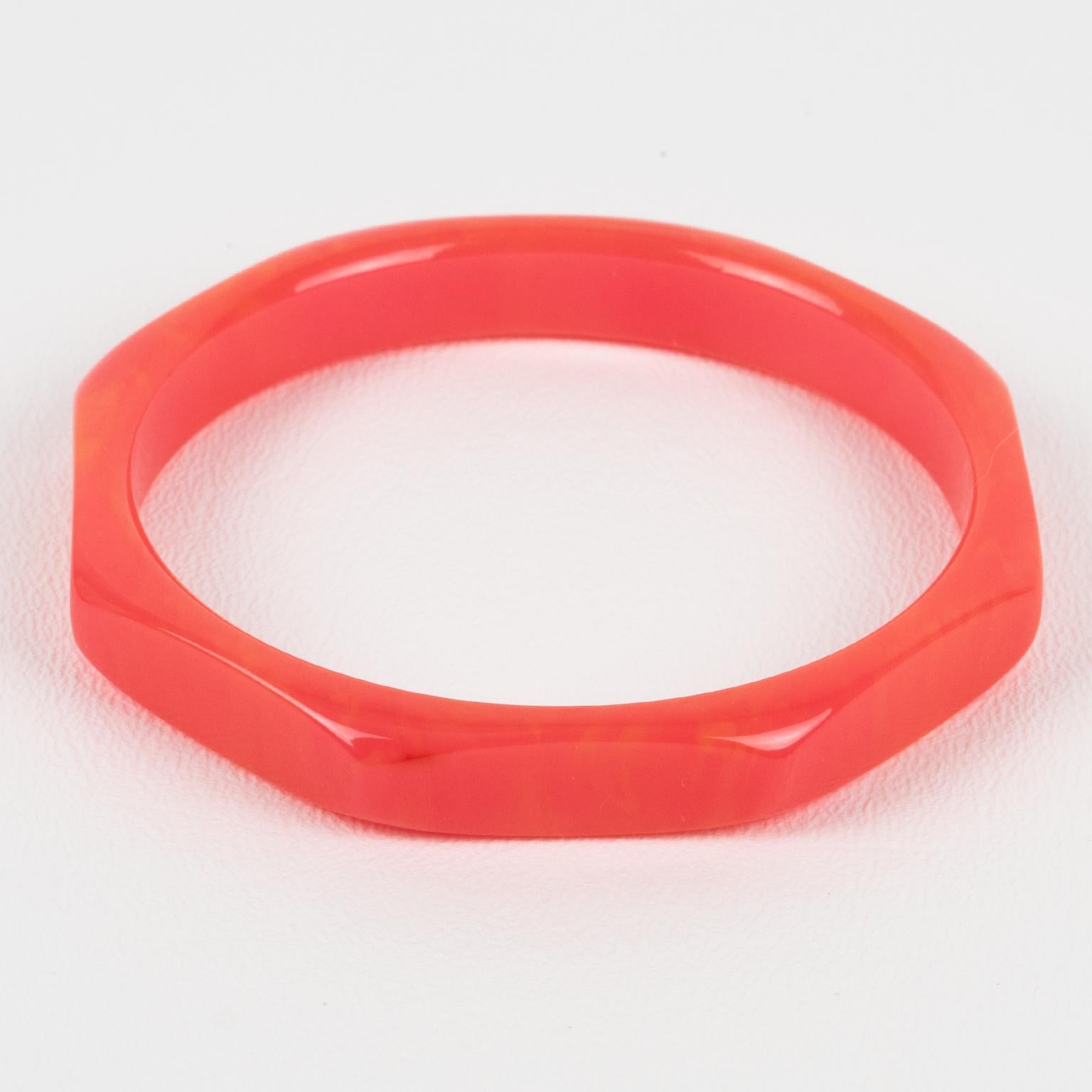 This gorgeous pink marble Bakelite bracelet bangle has a chunky octagonal spacer shape with deeply faceted and carved designs all around. It features an intense pink marble color with orange swirling, also called tequila sunrise color.
Measurements: