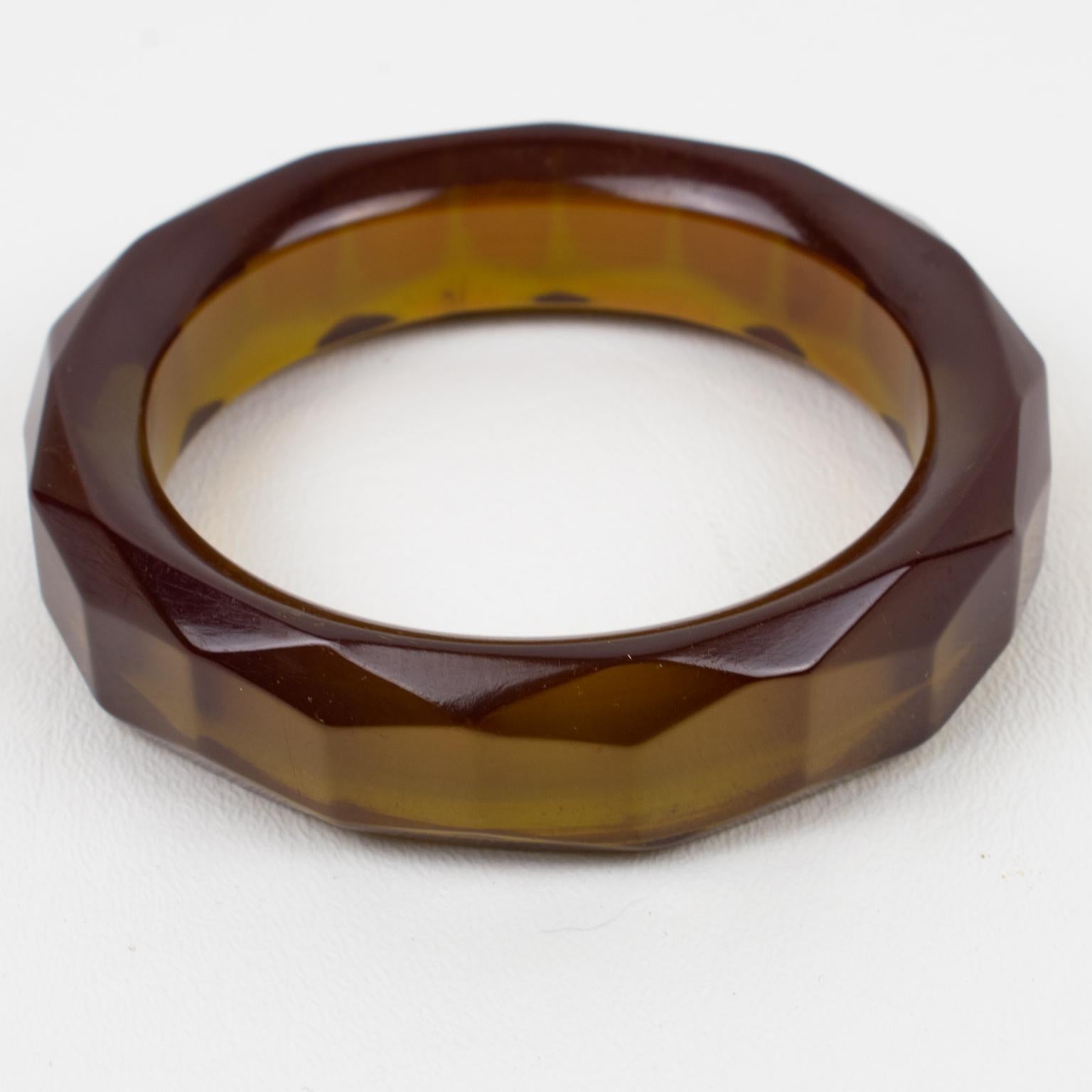 Stunning transparent olive oil Bakelite bracelet bangle. Chunky sliced shape with deeply faceted and carved design all around. Intense olive oil tone, all transparent green color with red-purple overtone on edges. This Prystal quality piece has all