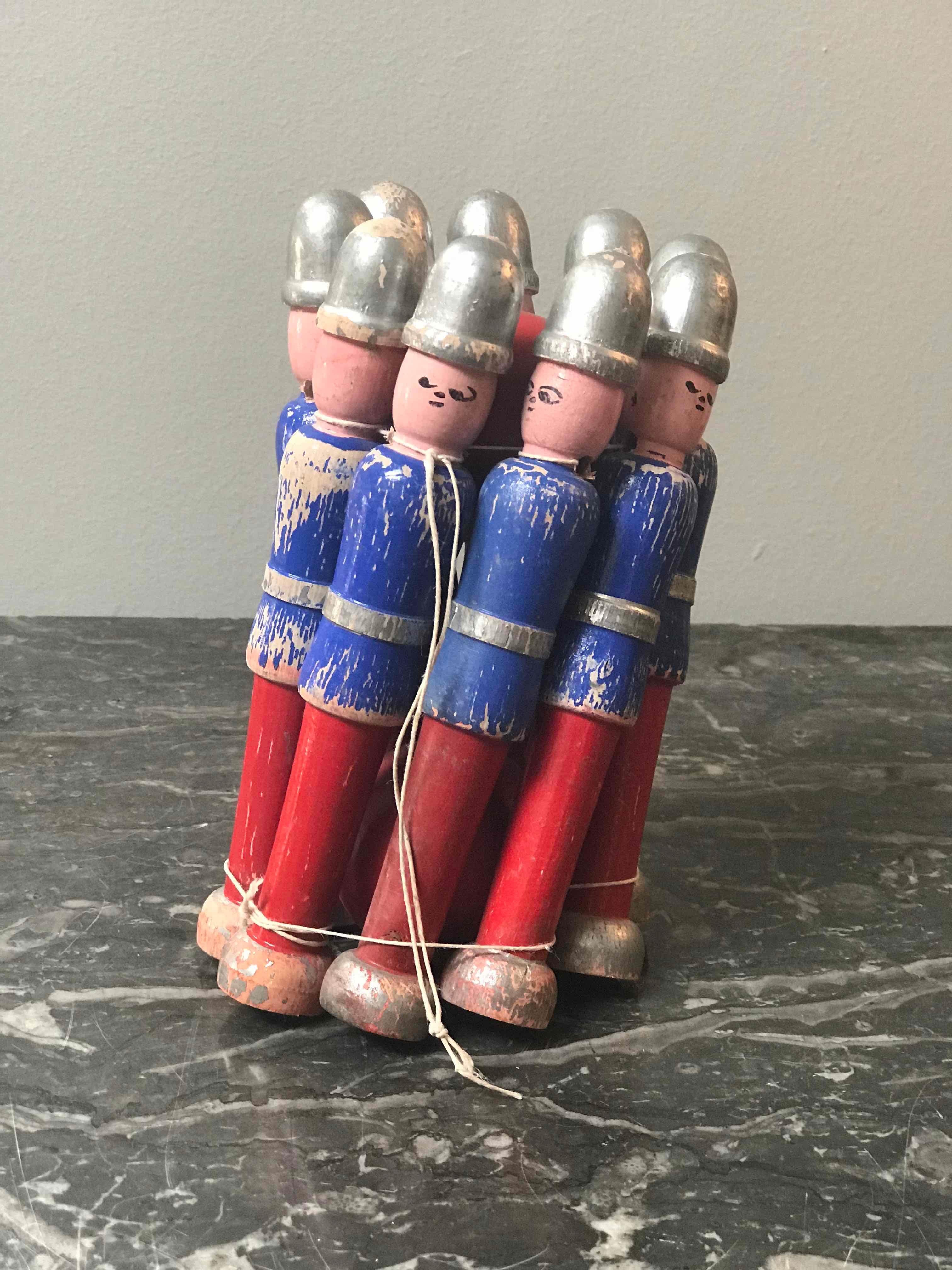 Carved and painted children's toy skittle game from England circa 1940. 