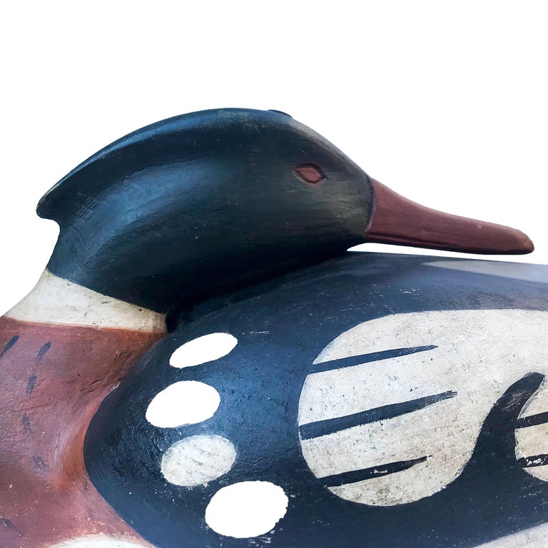 Red breasted Merganser Drake carved in a sleeping pose. Made from Tupelo wood with carved eyes, pinned head, attached flat lead weight and leather line tie
Great painted antique surface. Signed on the bottom
Made by renowned carved Frank Finney,