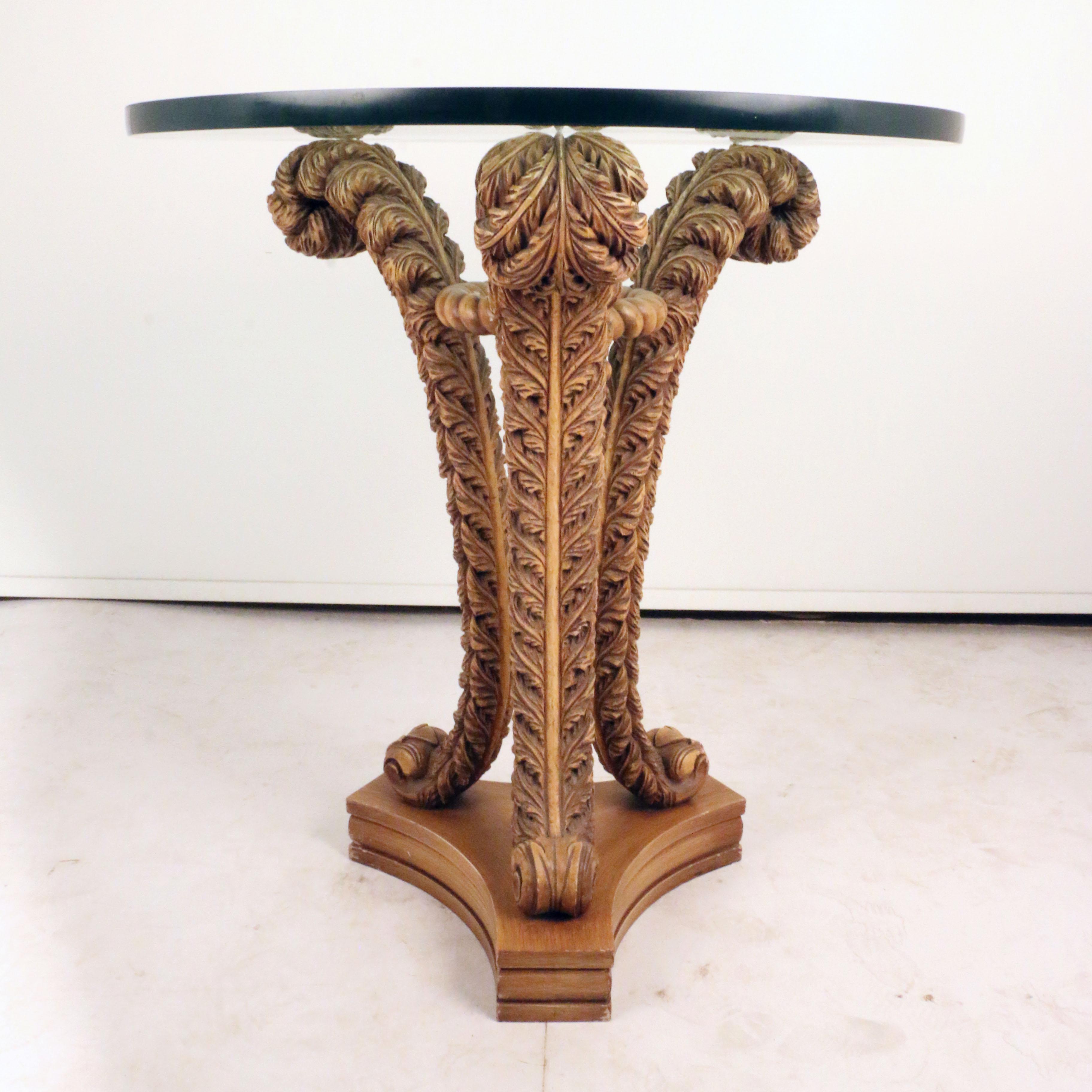 Standing on a trefoil base, and scrolling foot, the plate-glass circular top stands on three curved supports carved as stylised feathers, braced at the top by an annular band. This is a highly unusual form but has much in common with other Pistono