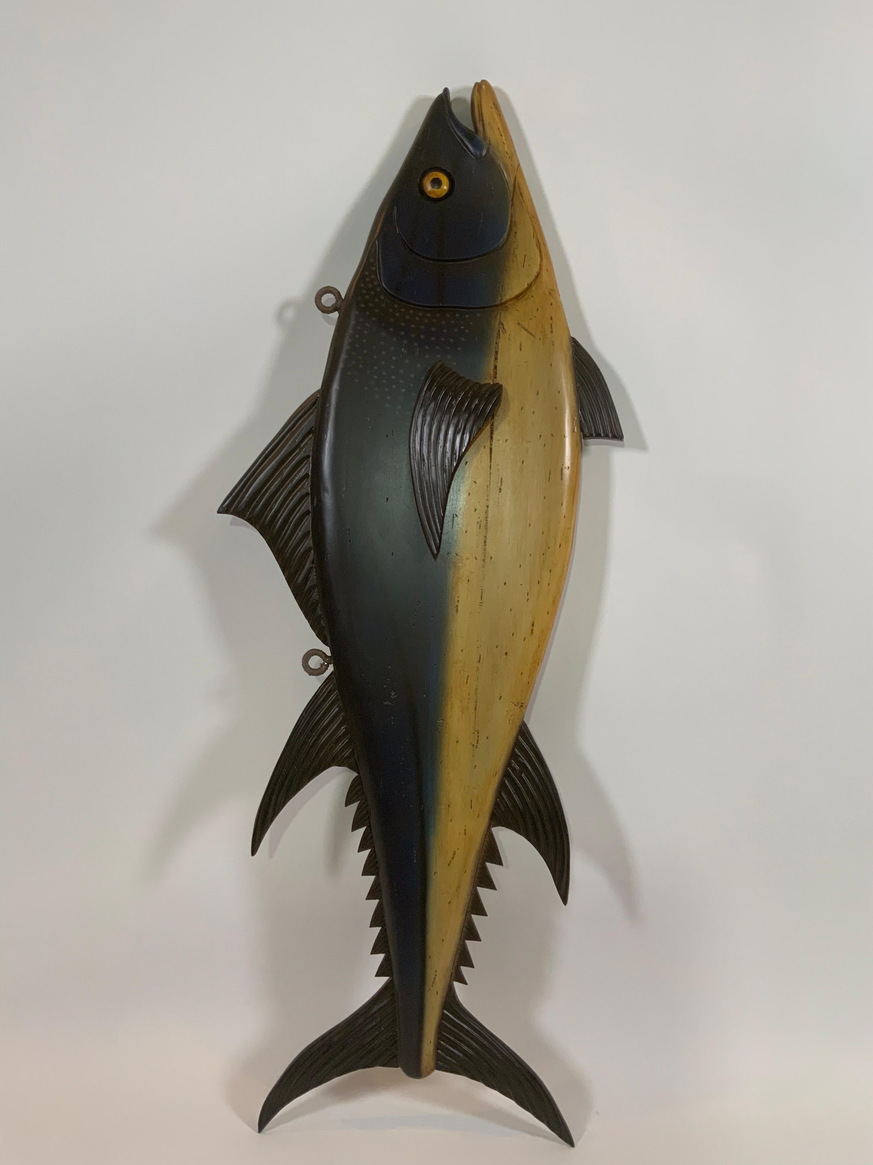 Quality carving of a yellow fin tuna. Painted body. Very well carved with fins, gills, eyes, tail, etc. Reminiscent of the signs that hung in the fish stalls at the Dover England fish stalls.


Overall Dimensions: 20