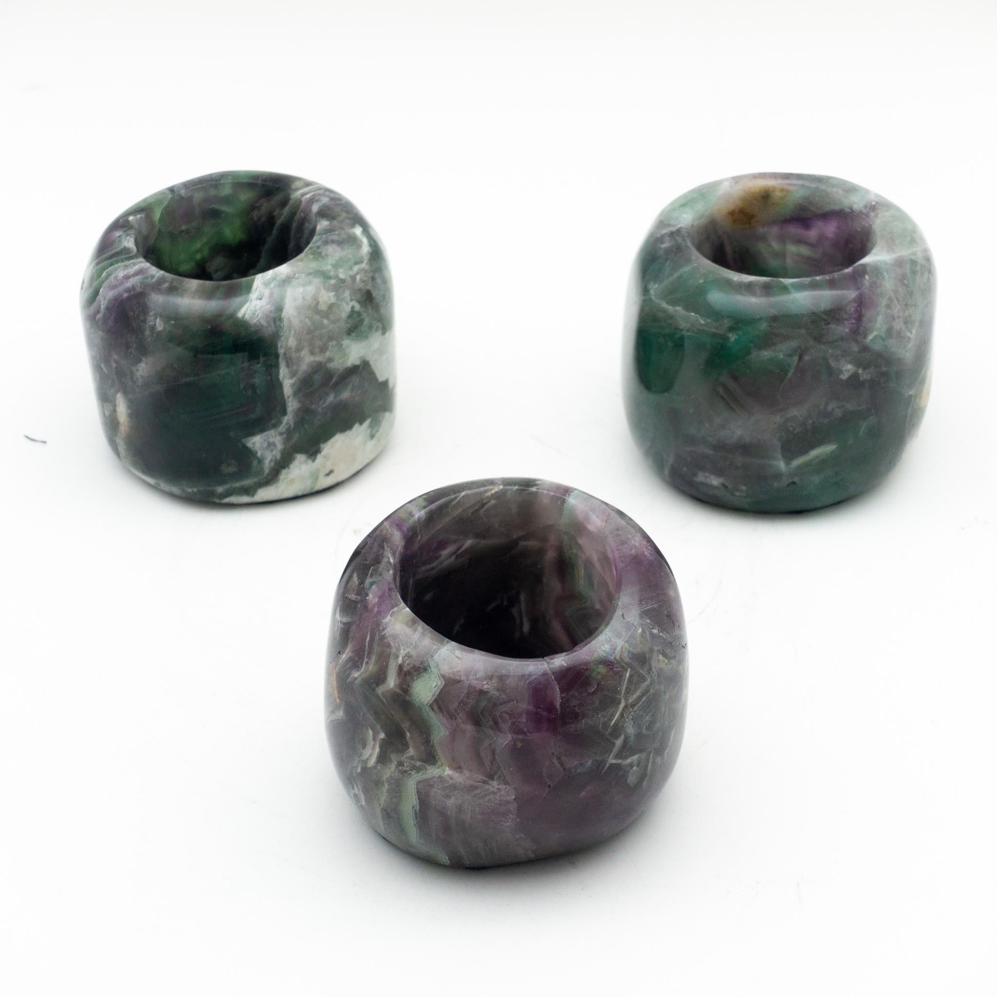 Set of three candleholders, carved from a pure fluorite specimen. 

Hailed as “the most colorful mineral in the world,” fluorite forms in a wide variety of hues, typically purple, green, yellow, blue, and in pure form - colorless, though specimens