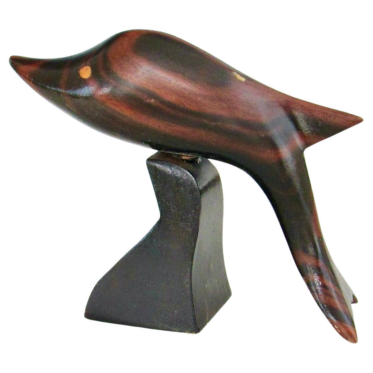 Carved and polished stylized rosewood desktop sculpture of a Dolphin