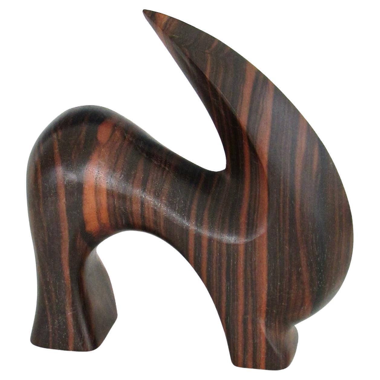 Carved and polished stylized rosewood desktop sculpture of ram or mountain goat