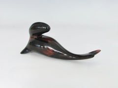 Carved and polished stylized rosewood desktop sculpture of sea lion