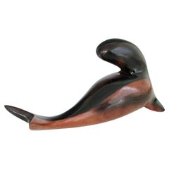 Carved and polished stylized rosewood desktop sculpture of sea lion