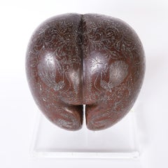 Carved and Silvered Coco de Mer on a Lucite Stand