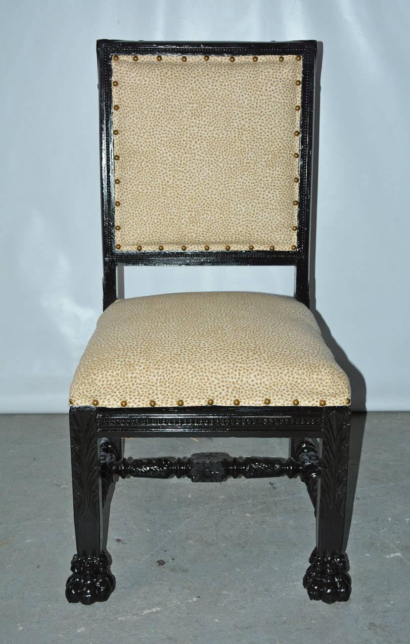 19th century Gothic Renaissance style ebonized side chair with boldly carved paw feet, upholstered seat and back. Newly reupholstered with small animal print fabric.

 
