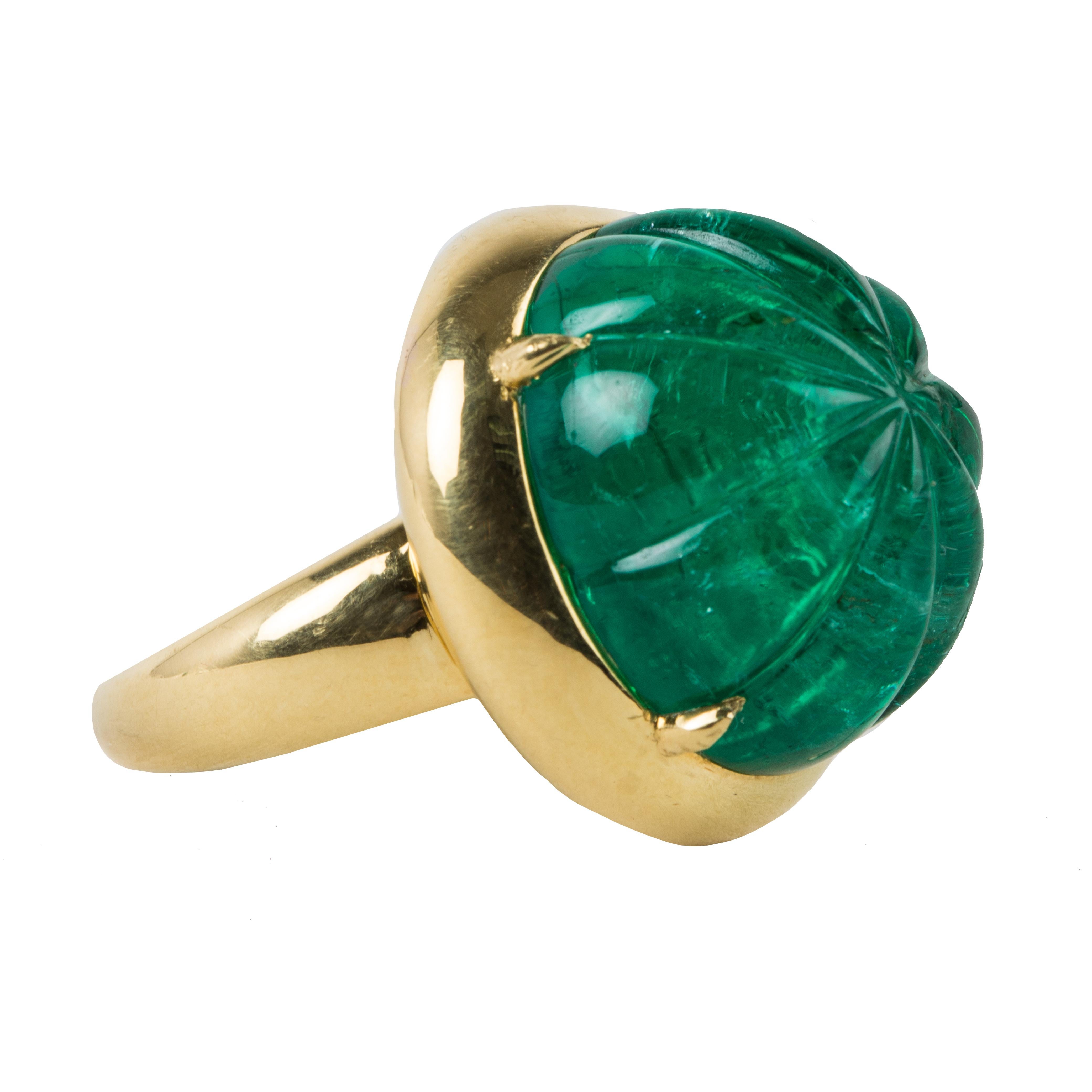 This is a 19 carat Colombian emerald ring, using an old mine emerald.
The stone has been carved and set with 4 prongs in platinum.