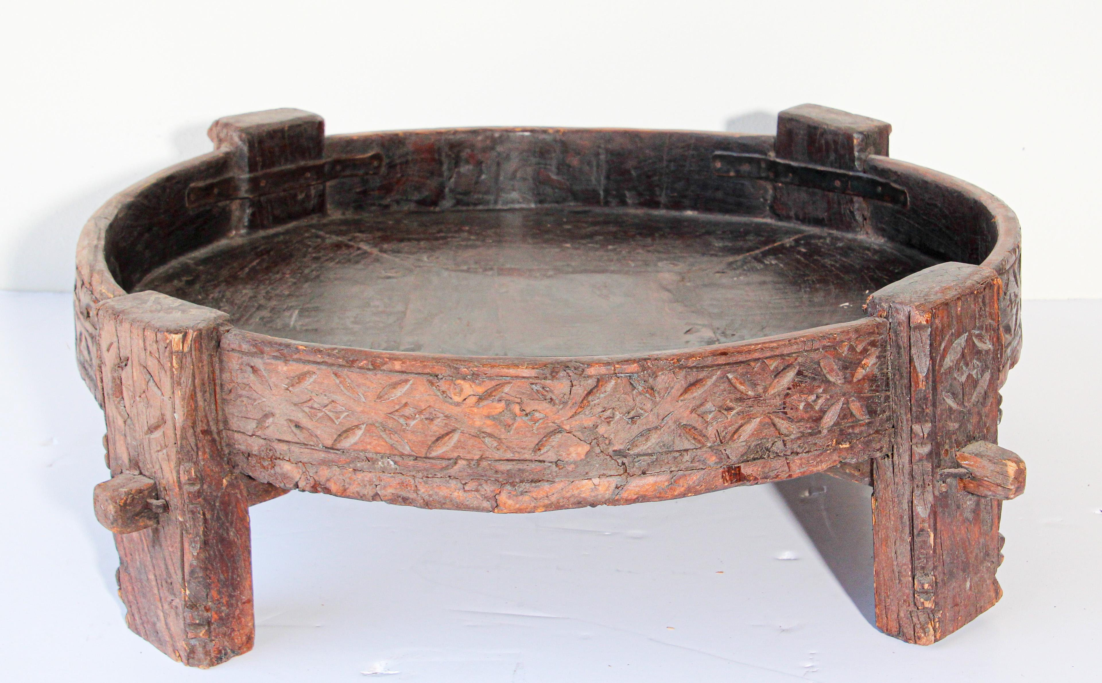 Large antique round hand carved wood Indian grinder tribal table.
Walnut color hand carved with geometric tribal design.
Handcrafted of wood and iron, hand carved with geometric Ethnic tribal design.
Very sturdy rustic wood table with nice