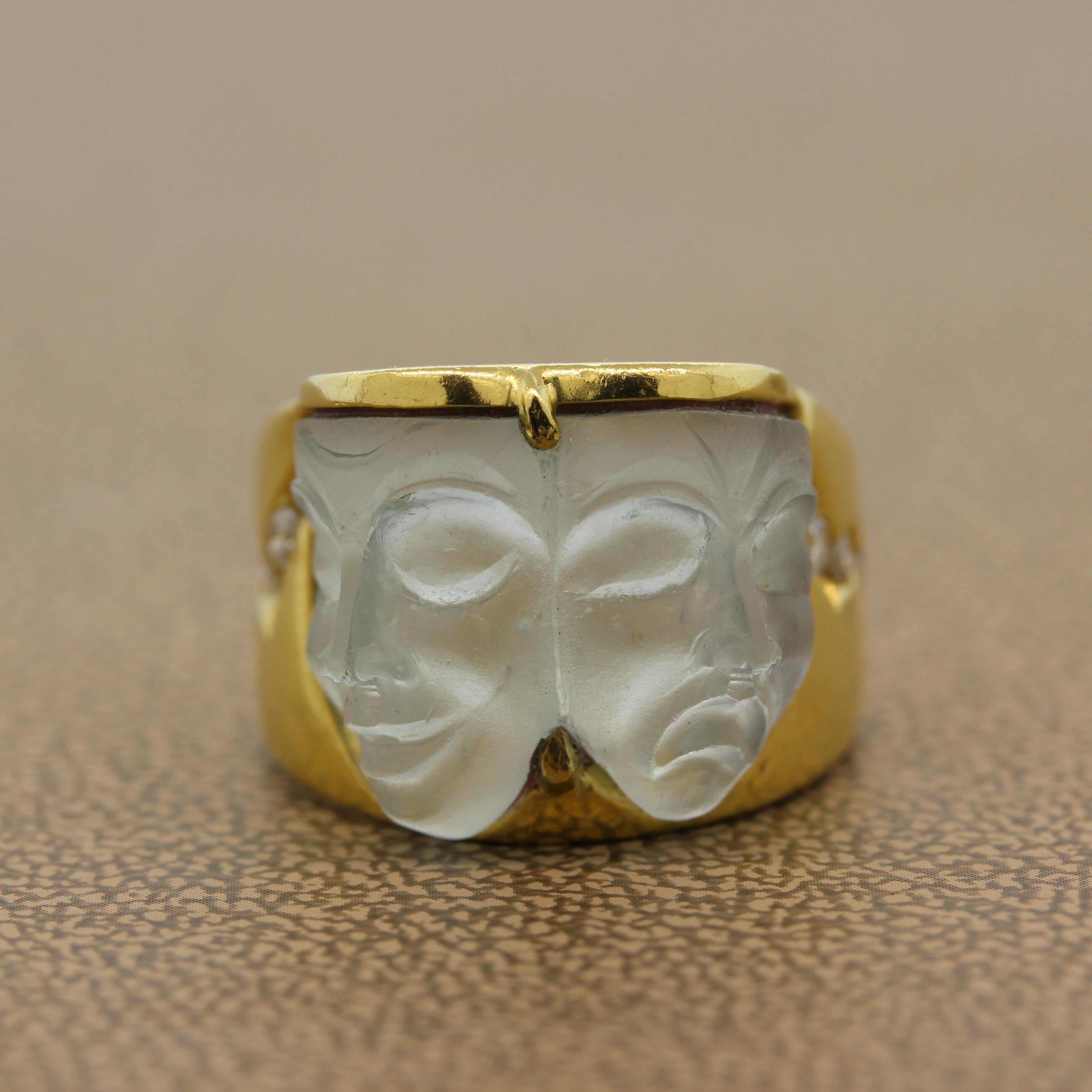 A ring full of character featuring the faces we wear. The two faces carved of aquamarine are of a happy face and a sad face. The masks are accented by round cut colorless diamonds set in 18K yellow gold.   

Ring Size 4.25 (Sizable)

