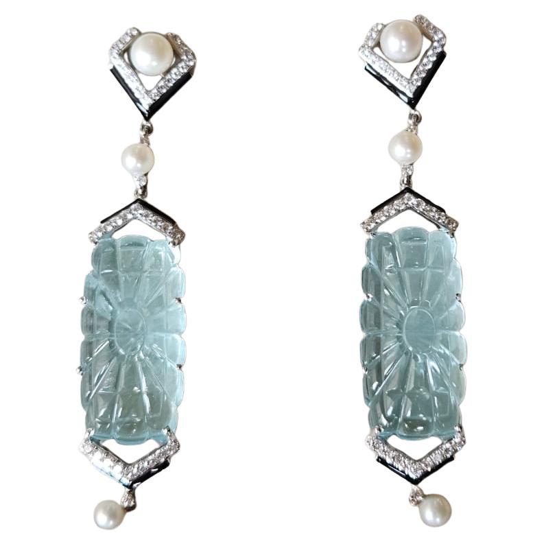A very gorgeous and special, Art- Deco style,  Aquamarine, Freshwater Pearls & Black Enamel Chandelier Earrings set in 18K White Gold & natural Diamonds. The weight of the carved Aquamarine is 47.50 carats. The Aquamarines are hand carved in our