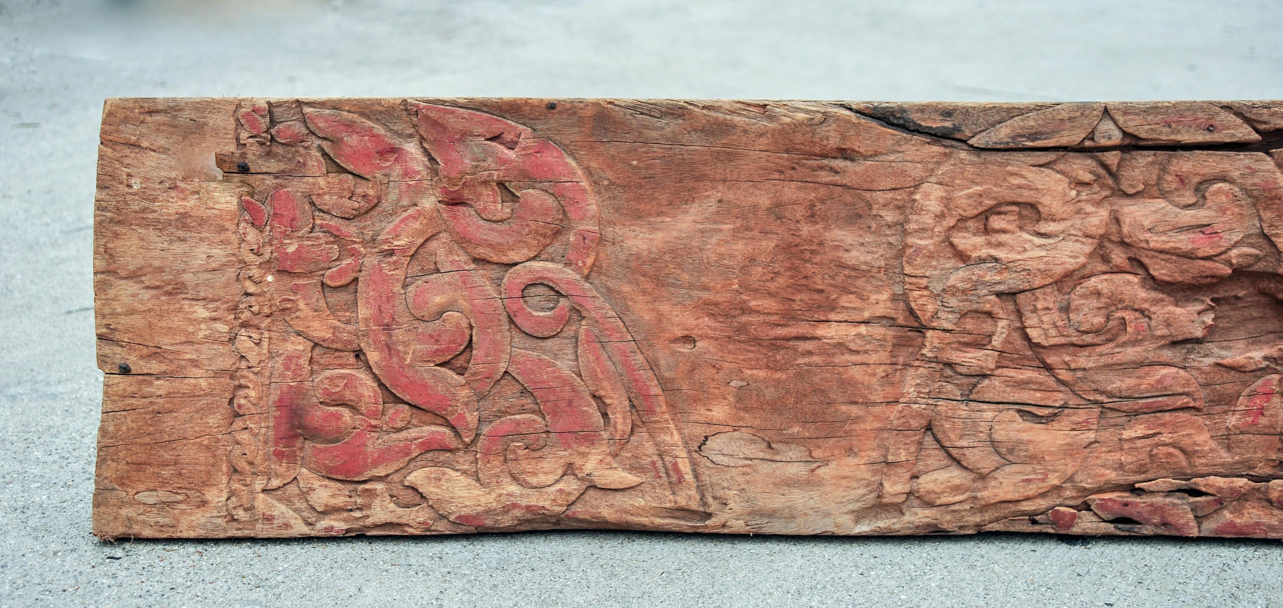 18 foot carved architectural beam. Dayak, Borneo Longhouse, mid-20th century.
This beam, taken from a Dayak Longhouse, comprises a single piece of wood and incorporates typical Dayak carved floral design elements, punctuated by remnants of original