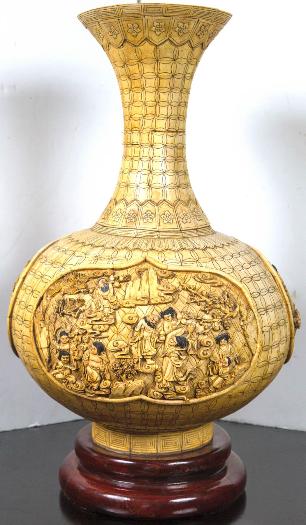 A three cartouches depicting scenes with people around the bulbous portion of the vase. Inside the opening at the top are carvings of animals. The vase itself is strictly decorative and will not hold water.
Pen work all around. Attached to wooden