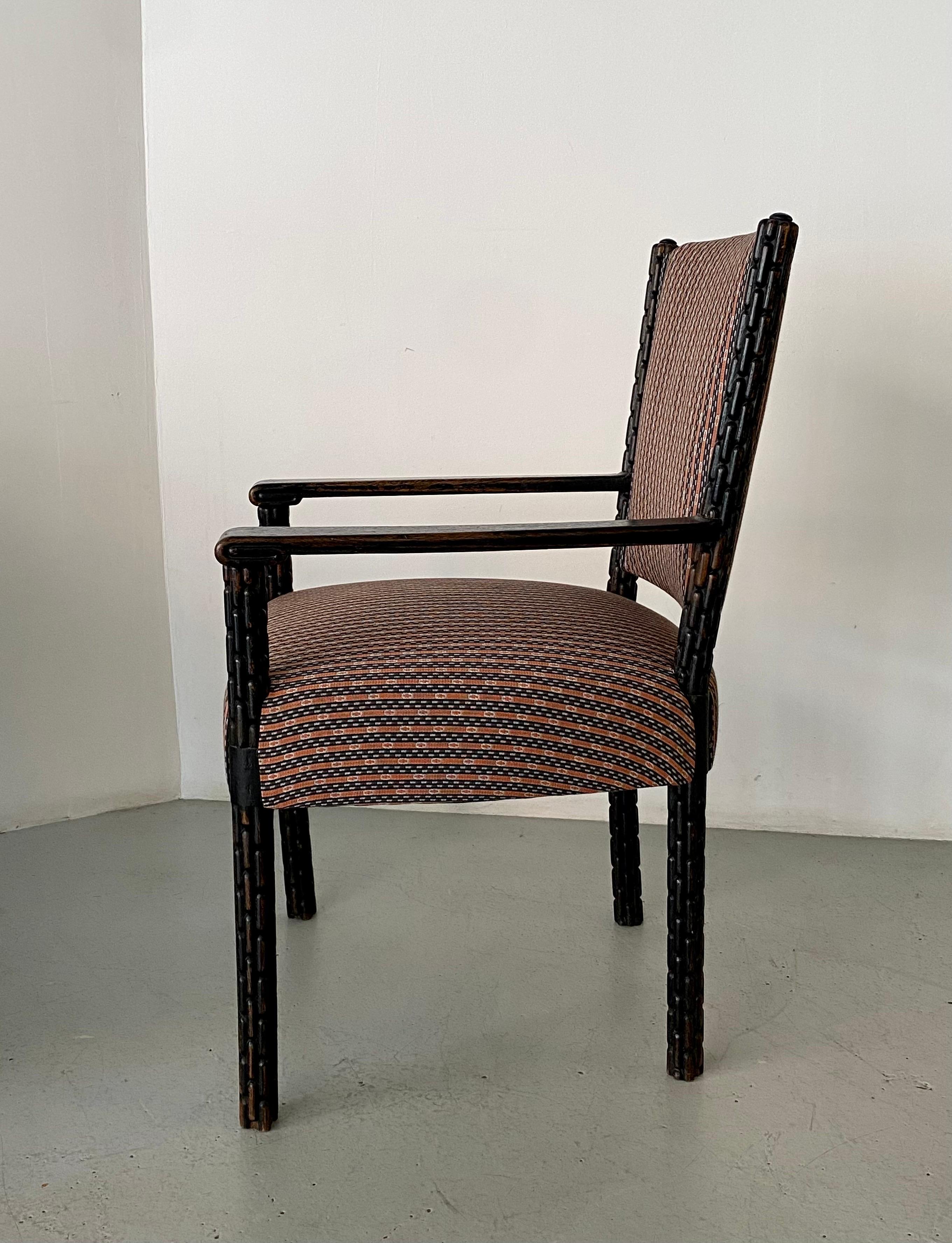 Hand-carved Austrian chair from the 1920s in black stained oak. Exquisitely carved details on legs and arms exemplify the craftsmanship of the era. Chair has been extremely well maintained and was recently reupholstered. Great for use as desk or