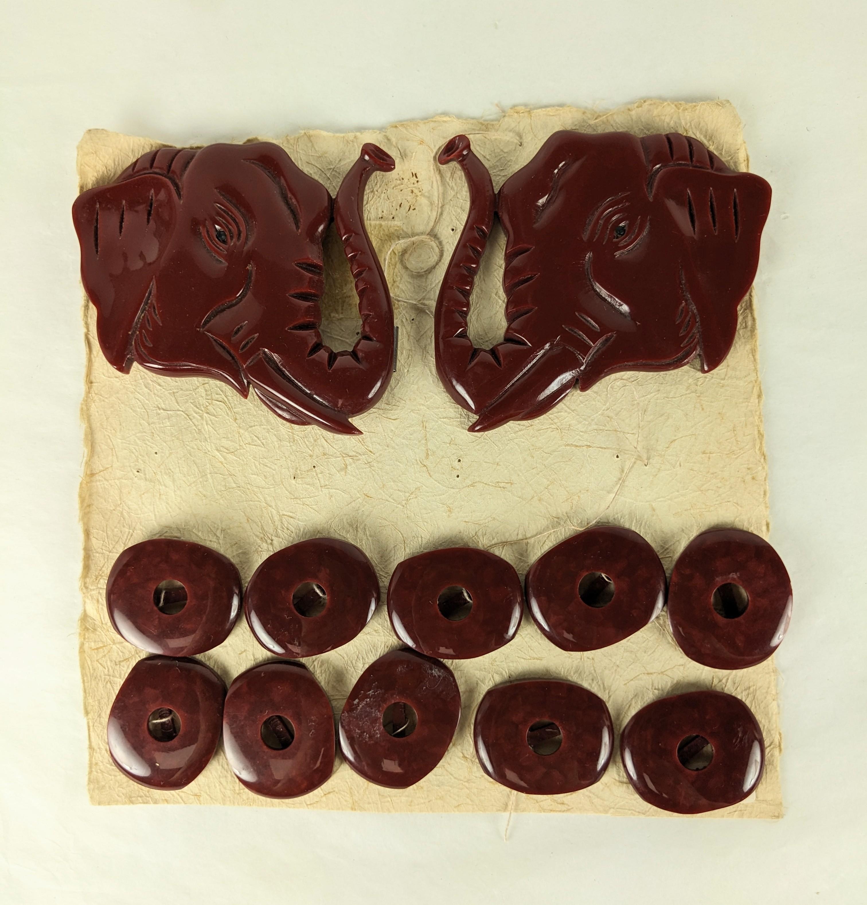 Amazing Carved Bakelite Art Deco Elephant Dress Suite from the 1930's. Huge pair of hand carved elephant heads set with jet eyes form a buckle with a set of 10 matching buttons. A charming high end option for the Art Deco client who wanted to update