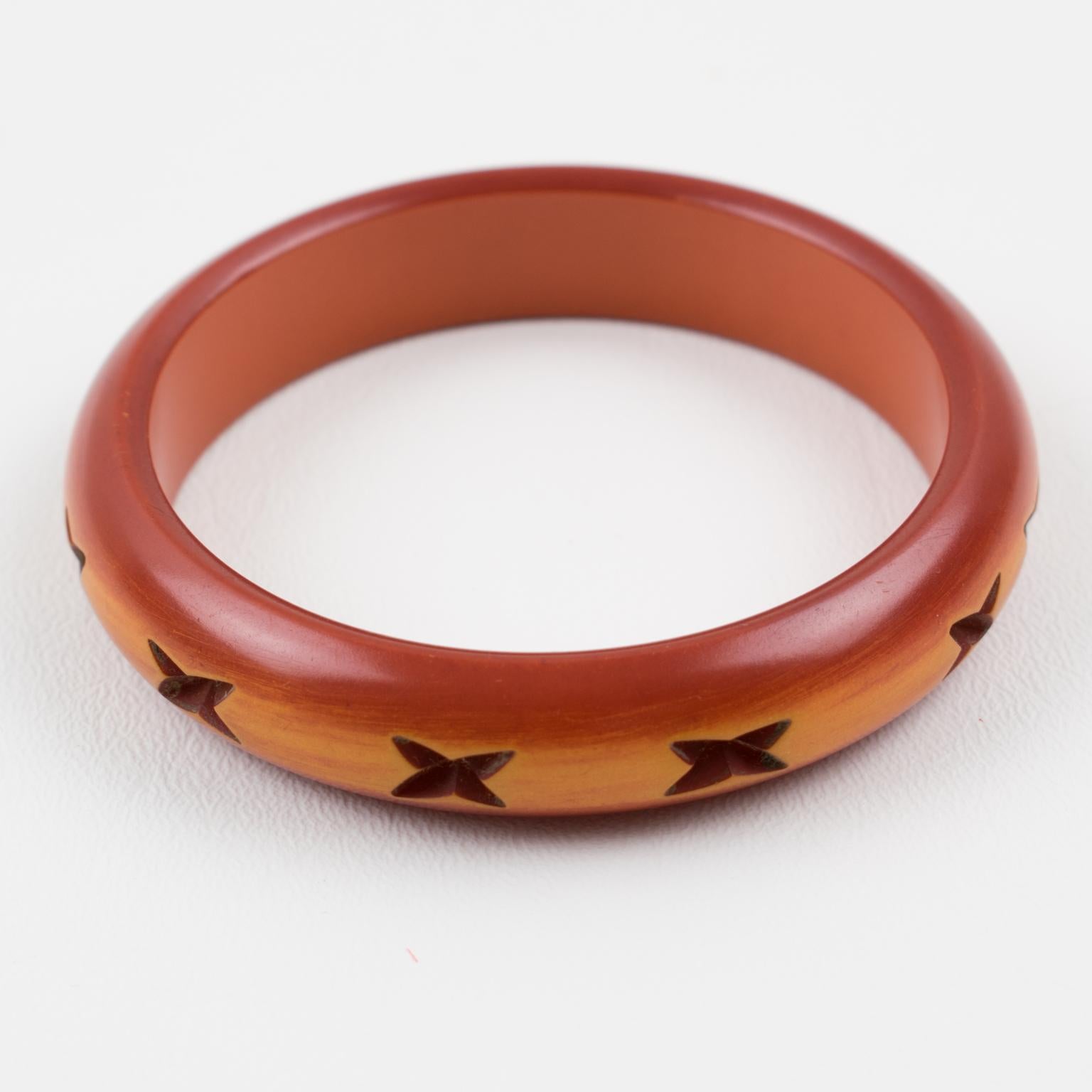 This stunning bi-color Bakelite carved bracelet bangle features a chunky domed shape with deep geometric carving all around, featuring an 