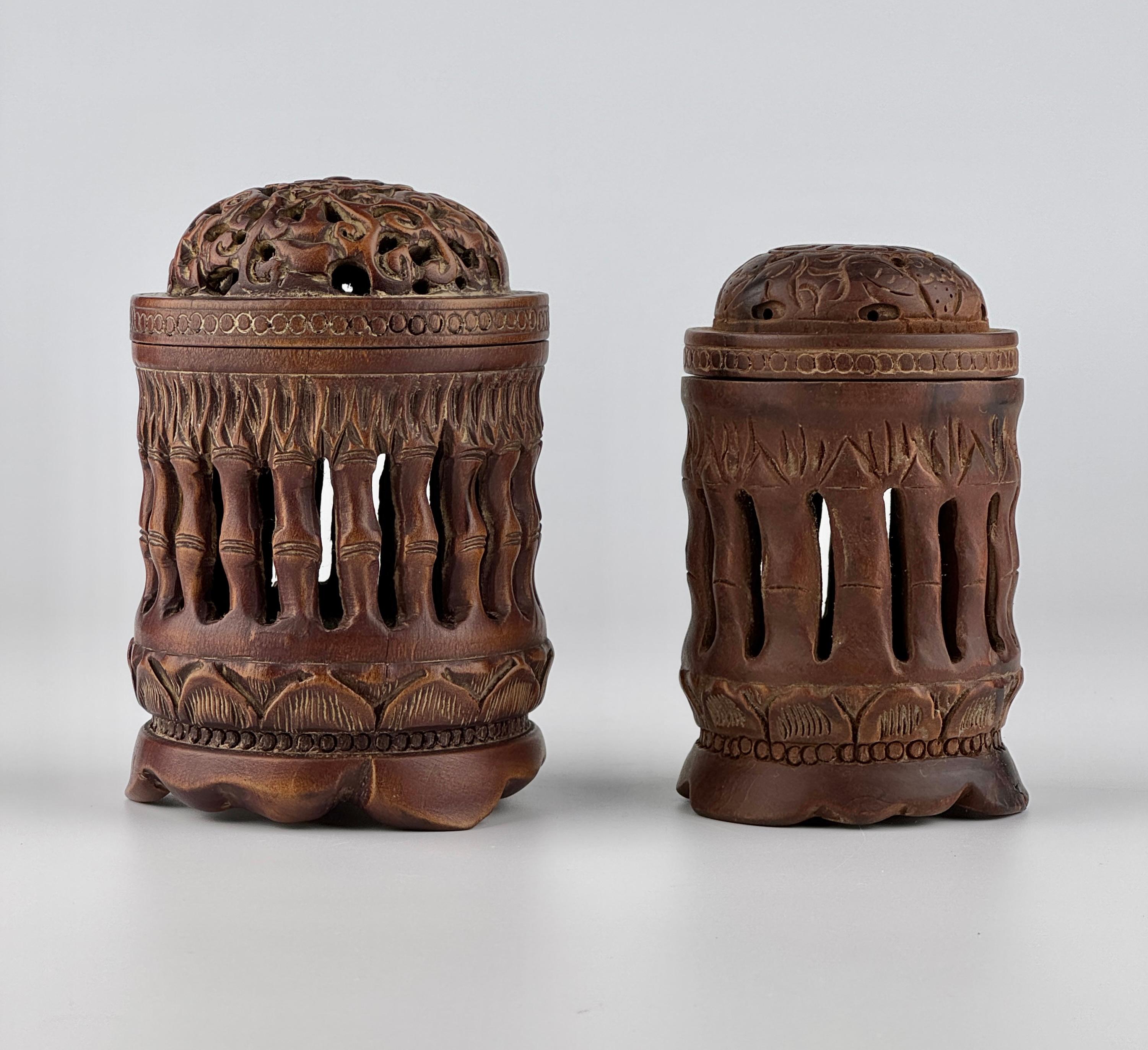 Each burner features a unique design with traditional pillar-shaped structures and intricate openwork carvings. The lids are adorned with delicate floral and nature-inspired motifs, allowing incense smoke to disperse elegantly.

Period: Late Qing