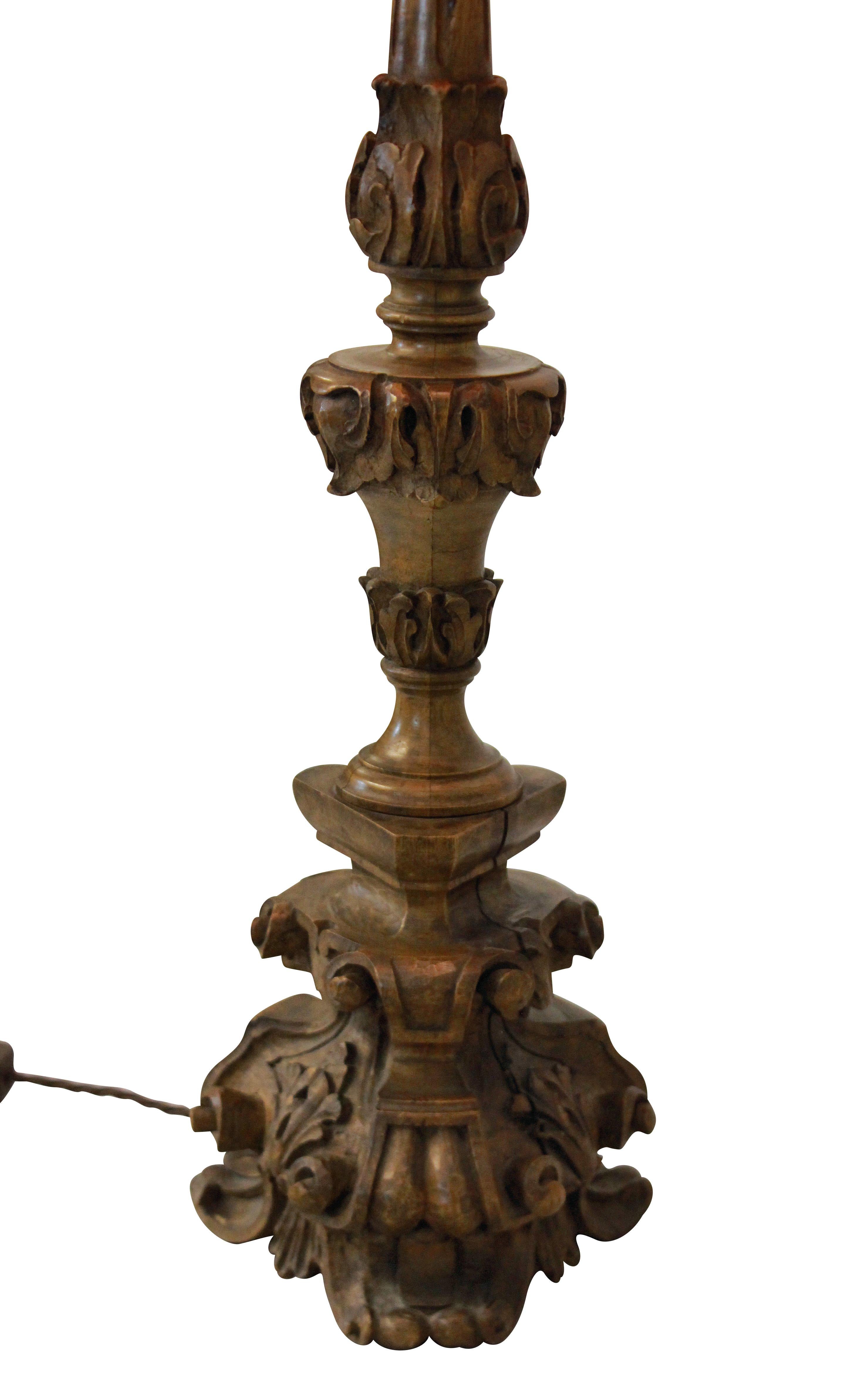 An Italian 18th century carved walnut pricket stick converted into a table lamp.

 