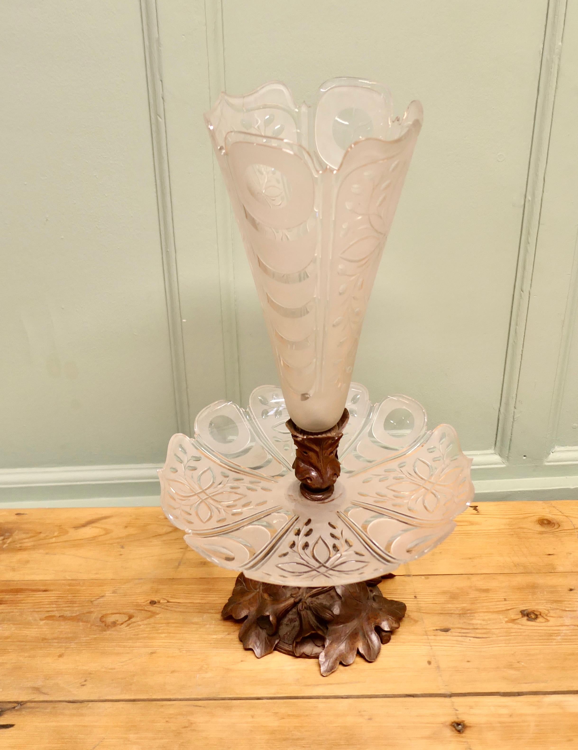 Carved Black Forest and Baccarat Crystal Epergne Centre Piece

A superb and very unusual combination, a Back Forest pedestal carved with oak leaves, mounted with an etched crystal dish, which in turn has another Black Forest carved mount holding a