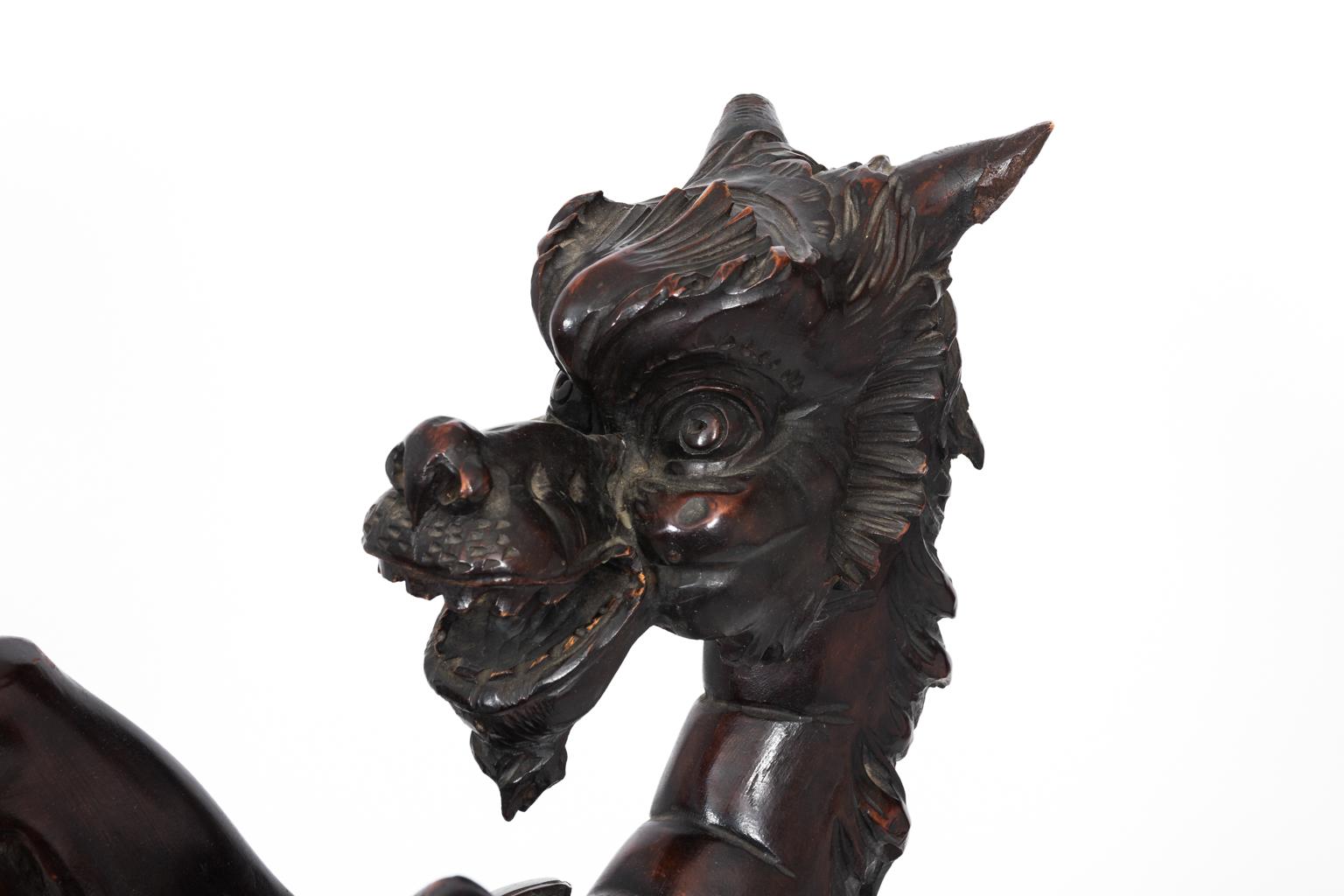 Carved Black Forrest mythological animal figure on stand in fruitwood. Please note that on there is some wear with age including missing leaves and minor chips, circa 1880.