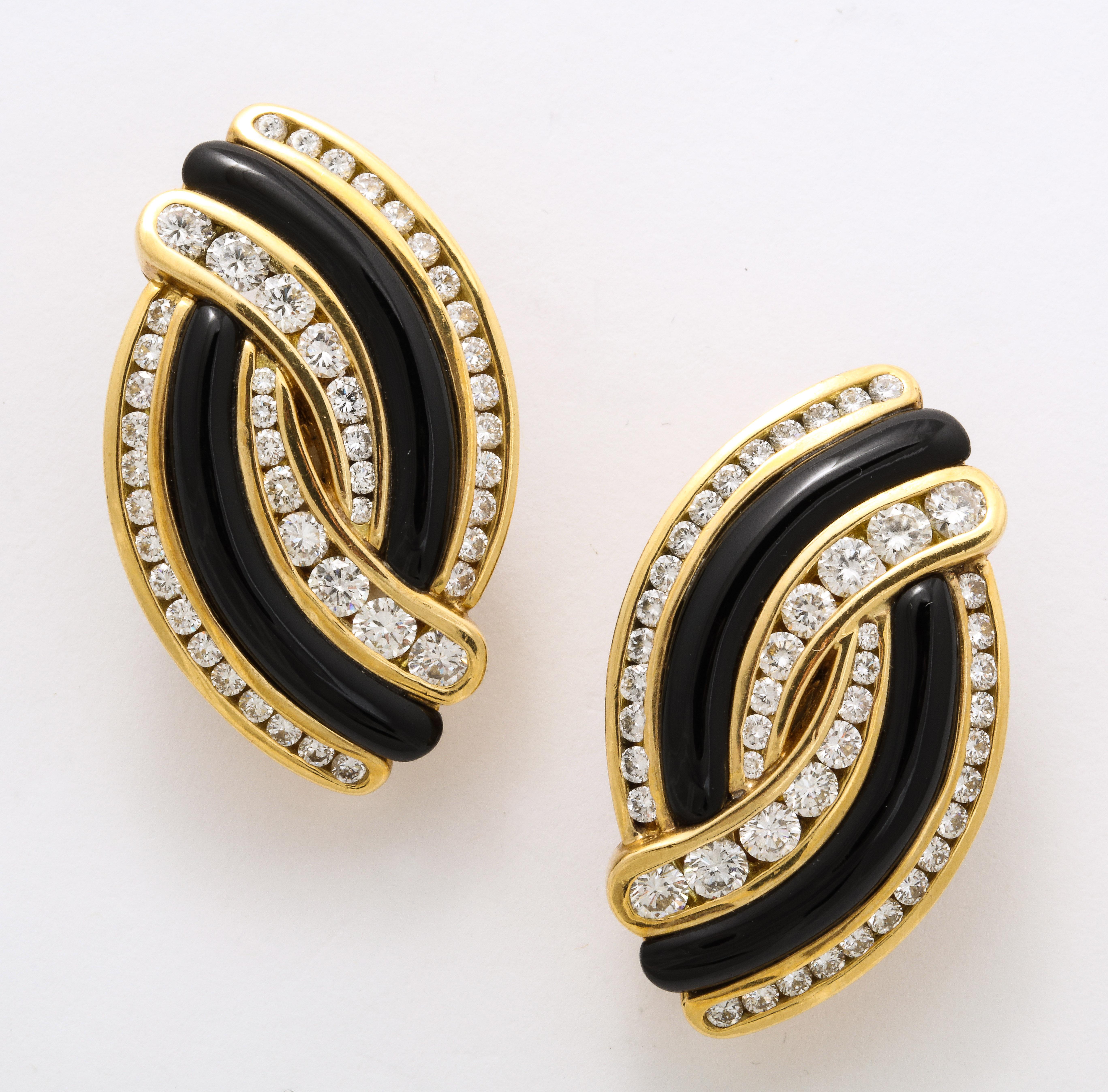 A perfectly elegant pair of 18K gold ear clips set with hand carved black jade curved elements complimented by diamond accents suitable for occasions or just shopping, lunch, and into evening. Measuring 5/8 inches x 1 1/2 inches. Weighing 43.7