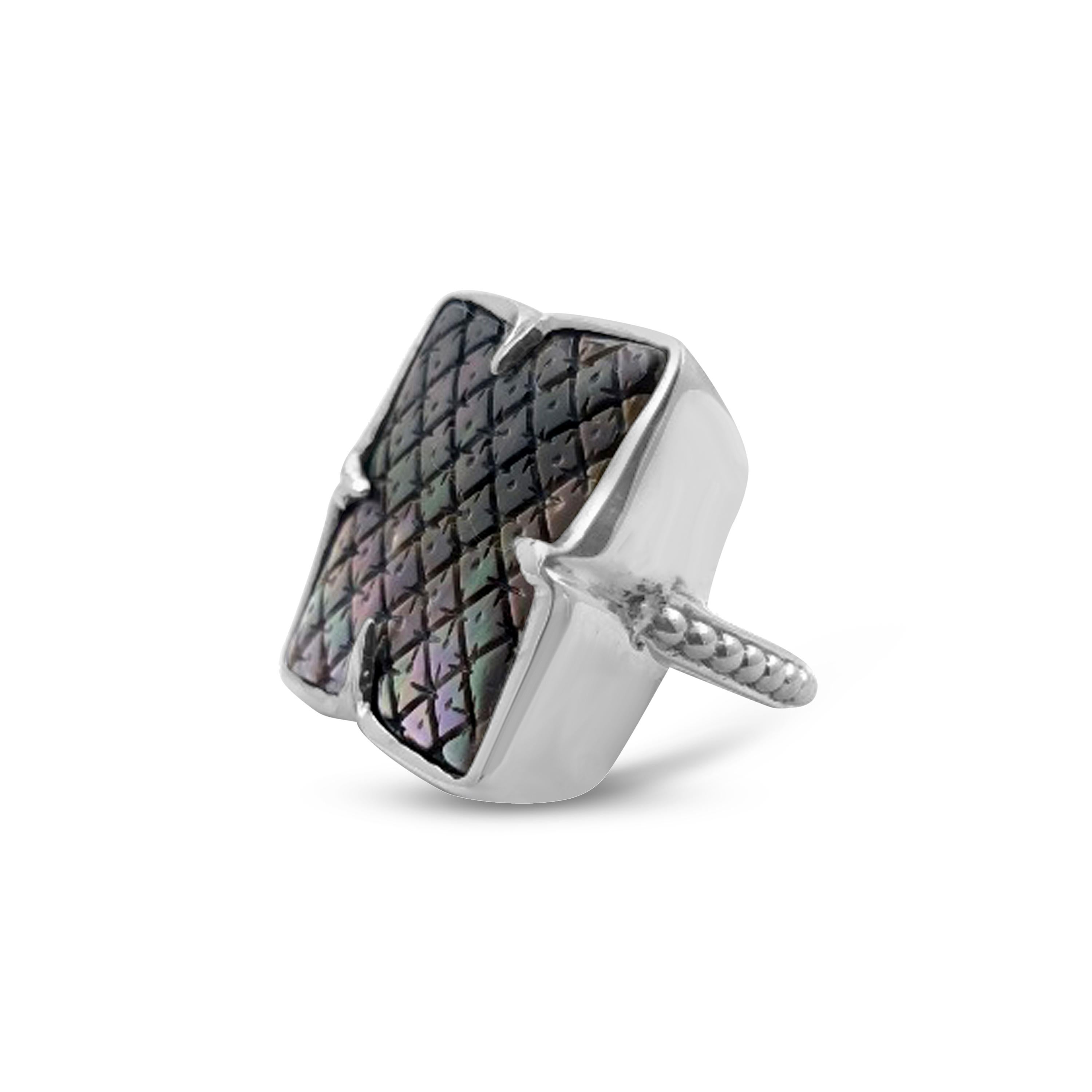 • Stephen Dweck Carventurous Collection  
• 925 Sterling Silver
• 0.98” X 1.05”
Indulge in the exquisite luxury of Stephen Dweck's latest masterpiece, a carved black mother of pearl ring in sterling silver. Skillfully crafted by master artisans,
