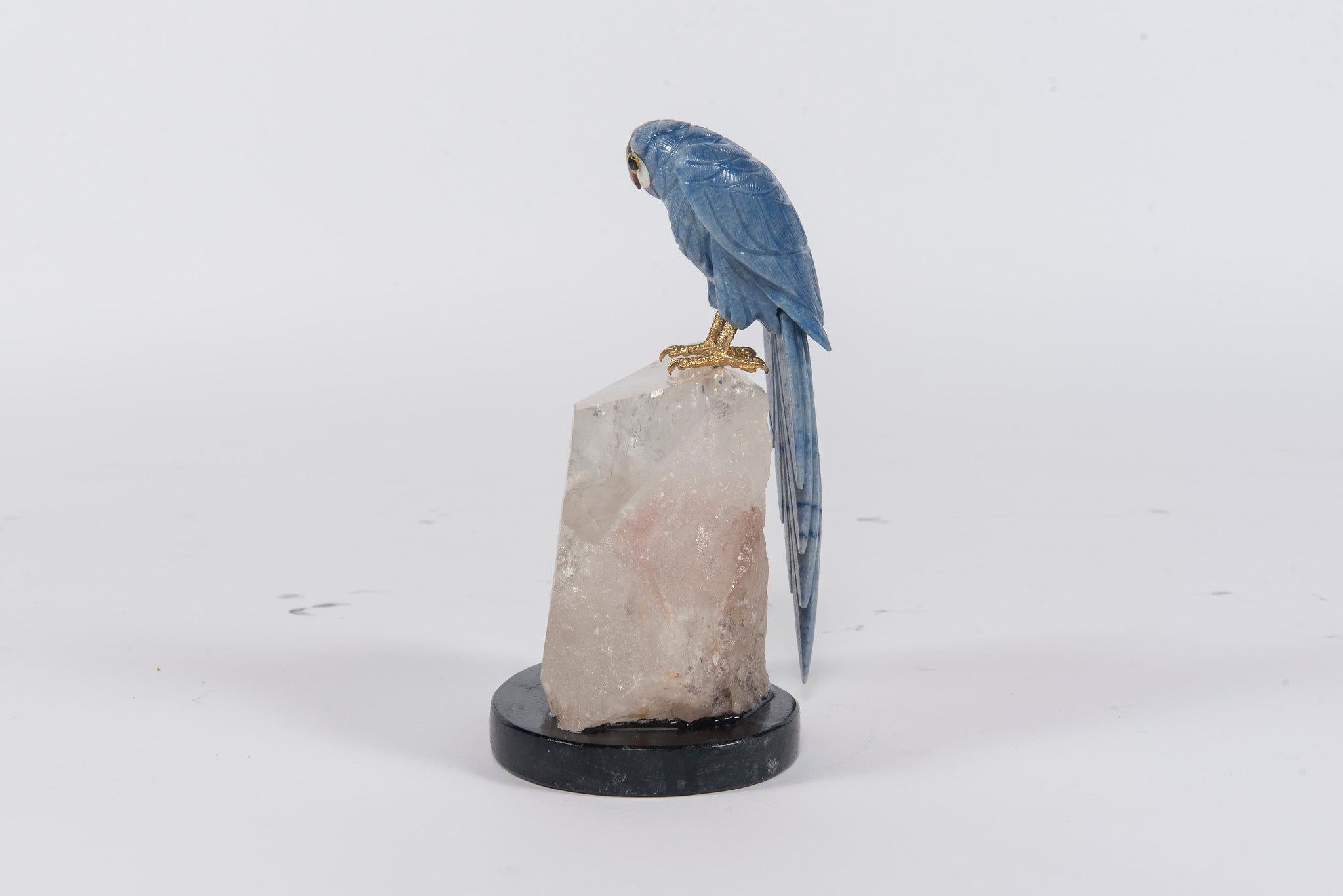This stunning hand carved blue angelite parrot has a tiger eye beak and is mounted on a large quartz specimen. This exotic bird is a brilliant decorative combinations of ornithology and geology.