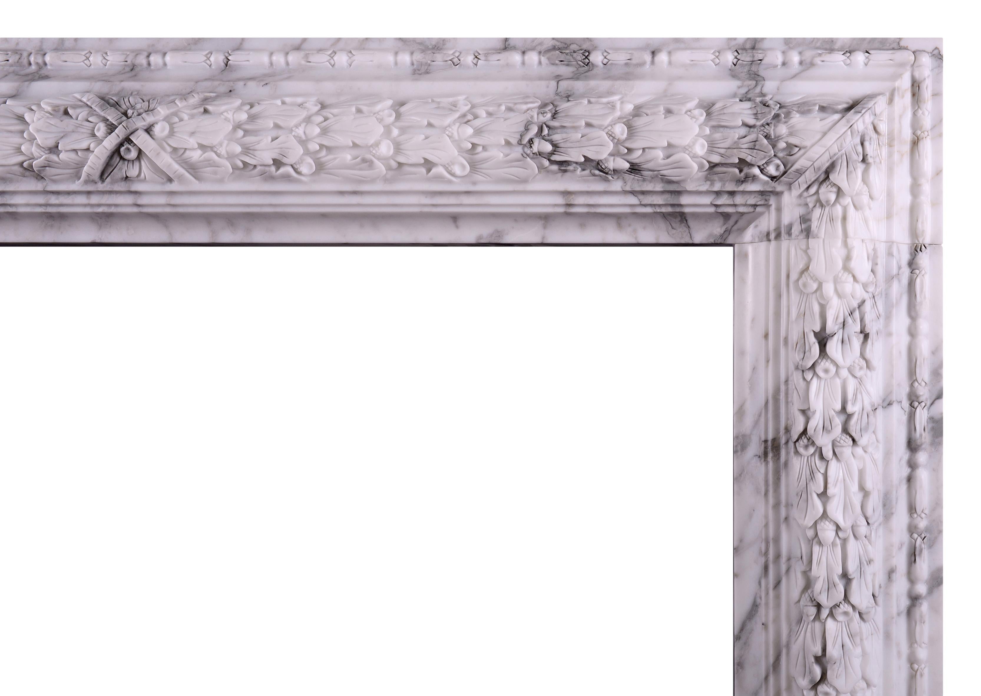 An elegant and understated bolection moulded fireplace in Italian Arabescato marble. The frieze with carved oak leaf decoration and crossbanded centre ribbon. A copy of a period original. Could be made to any size in various materials if