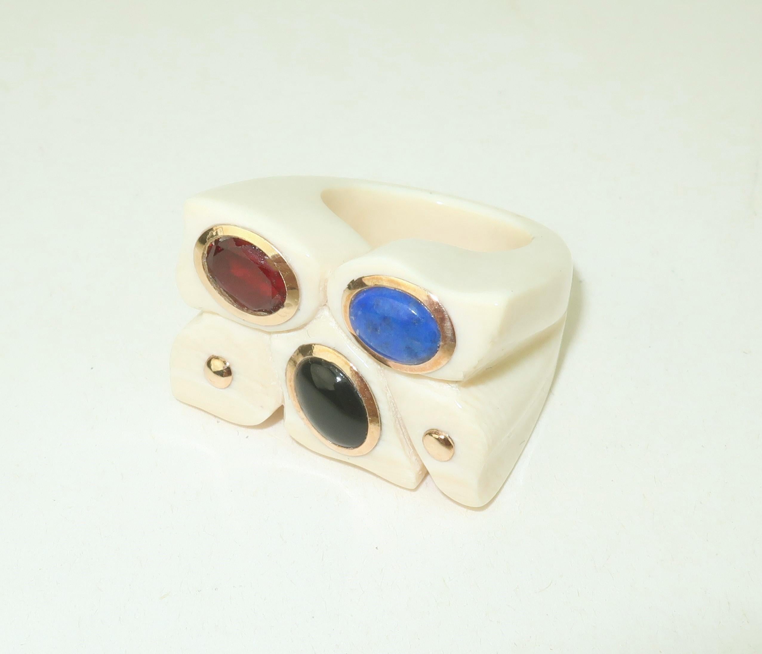 1970’s carved bone ring with semi precious stones accented by 14K gold bezels and studs.  The unique sculptural ring shape is eye catching and the perfect back drop for an onyx, lapis and garnet accent.  Vintage chic with a Studio 54 style! 