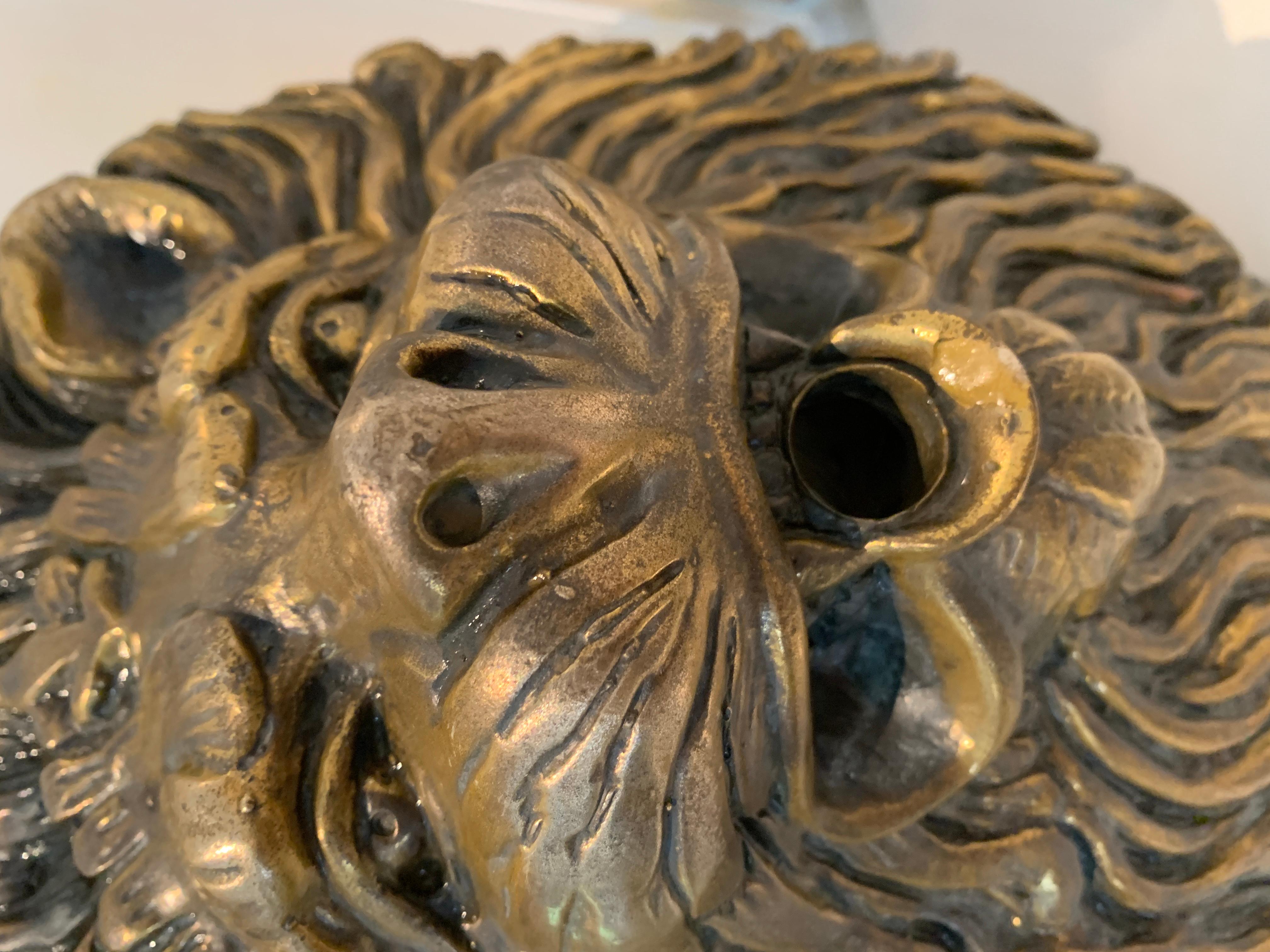 Carved brass lion fountain head - a wonderfully detailed lion head, molded clay or terra cotta on the reverse. The lions mouth has a 3/4