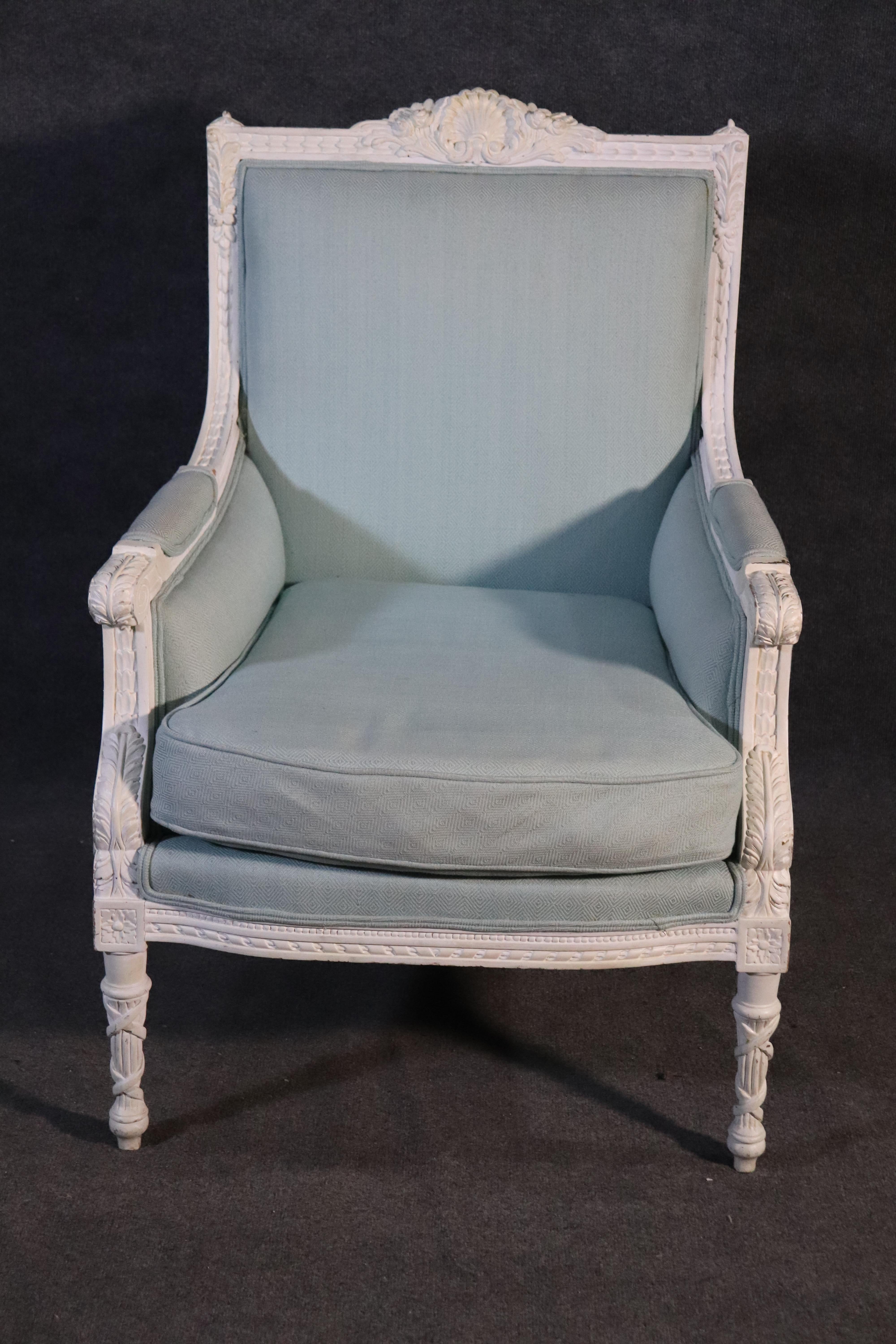 This is a beautiful blue and white French Louis XVI bergère chair. The chair features gorgeous blue upholstery of high quality and bright white distressed painting on the frame. The chair make a great first impression and is cheerful and bright. The