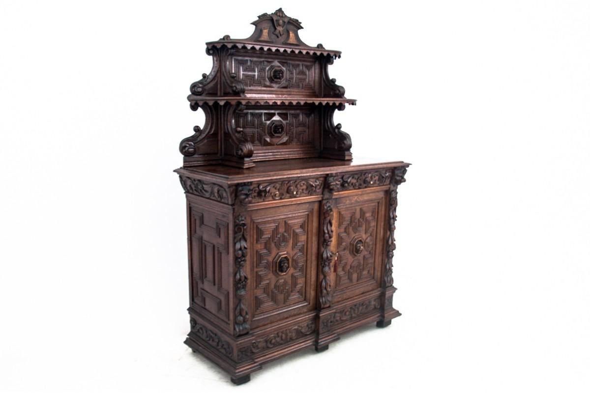 Richly carved side buffet made of oak wood. 
Produced in France in circa 1880.
Preserved in very good condition.
Dimensions: height 210 cm / width 140 cm / depth 54 cm.