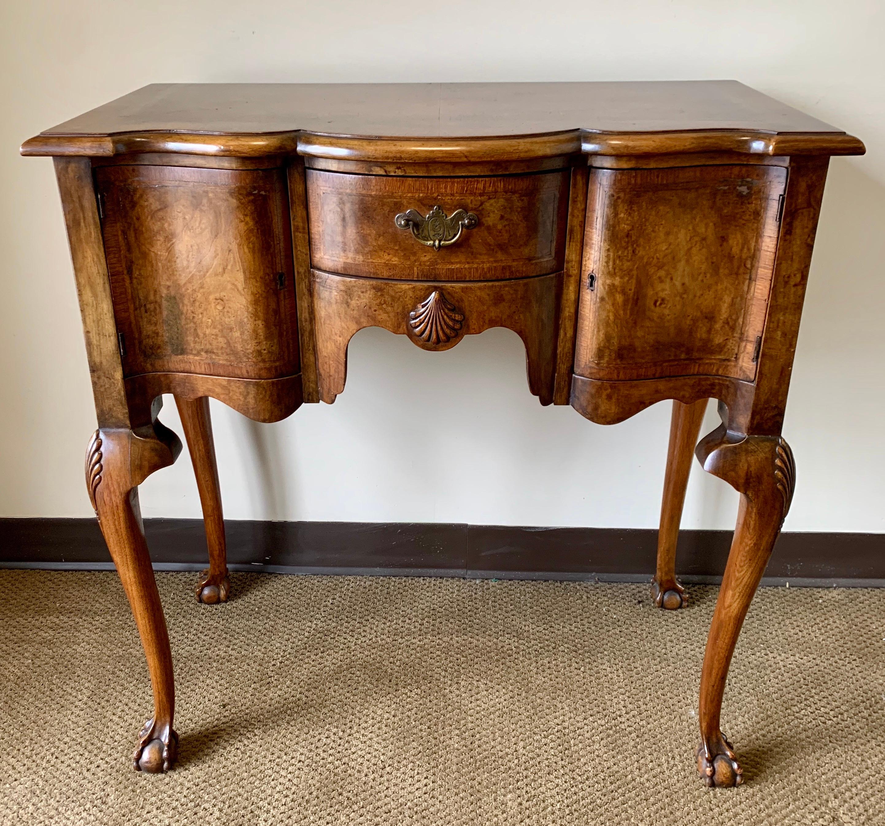 Coveted carved burled walnut console table with black lacquer and gold hand painted mirrors above. The table has storage and key to lock which make the possibilities endless. Dry bar, console table, accent table, foyer piece - your call! Dimensions