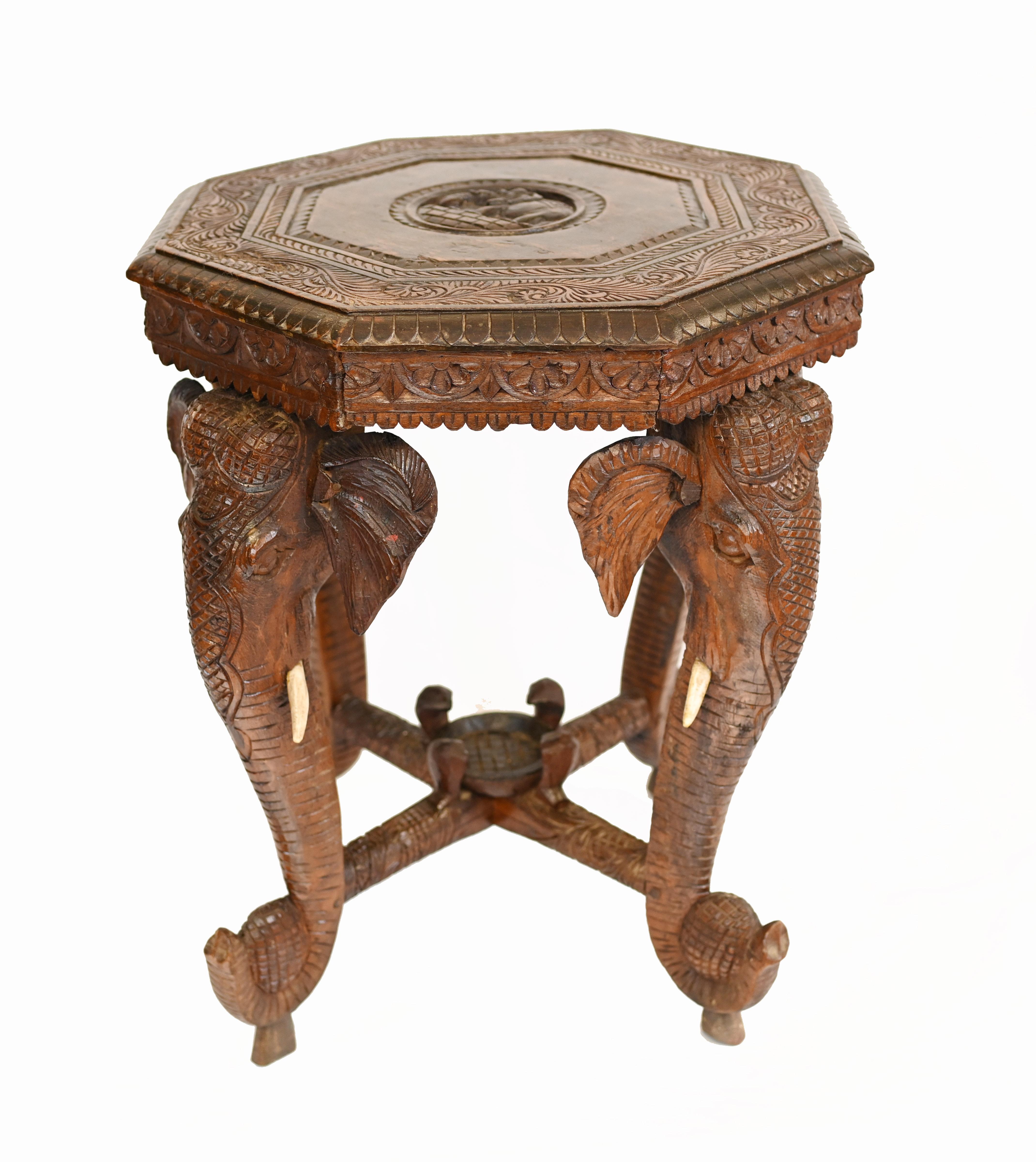 A fine Burmese elephant table heavily carved with a hexagonal top supported by four elephants with simulated wooden ivory tusks
Circa 1880
Highly collectable interiors piece
Some of our items are in storage so please check ahead of a viewing to