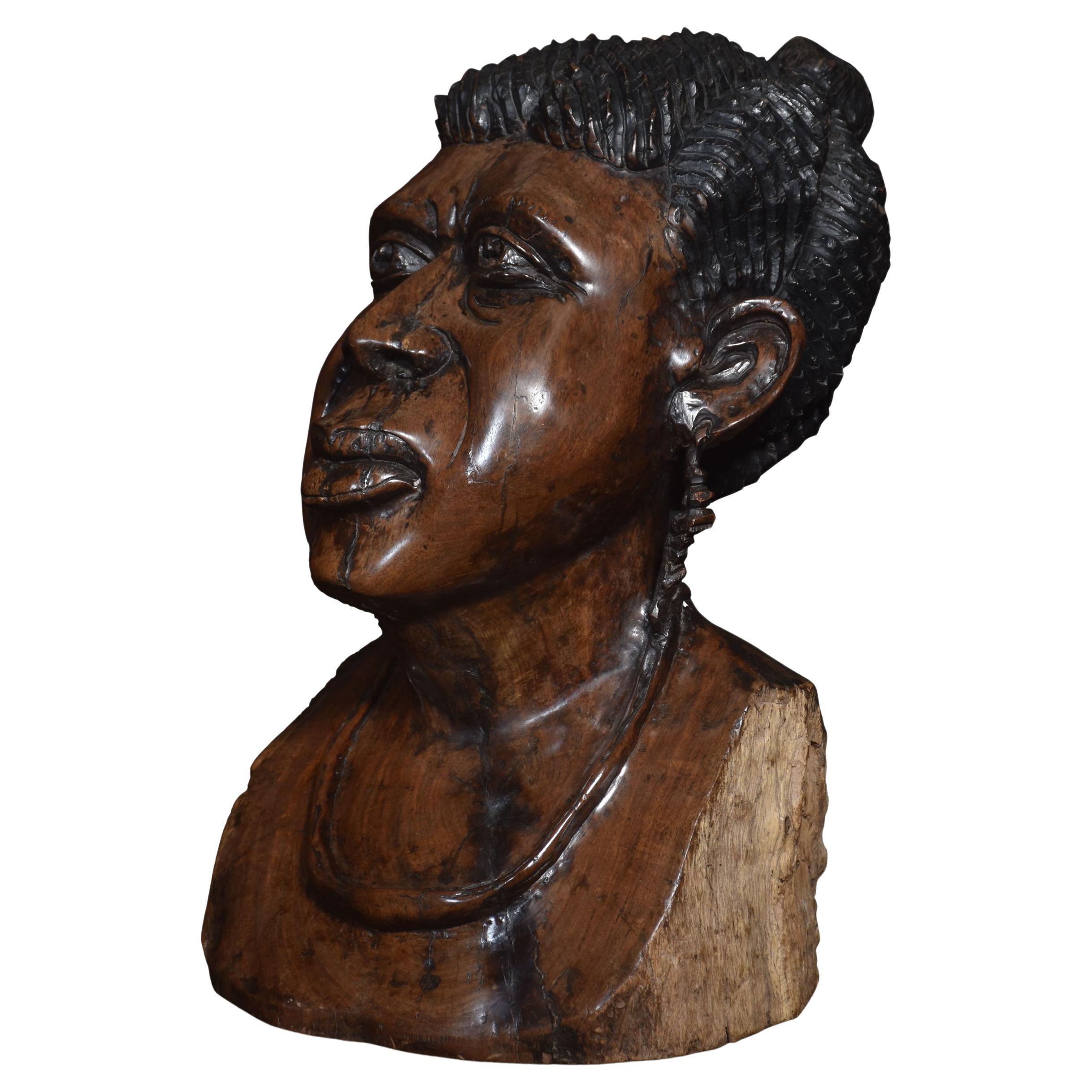 Carved bust of a tribeswoman For Sale