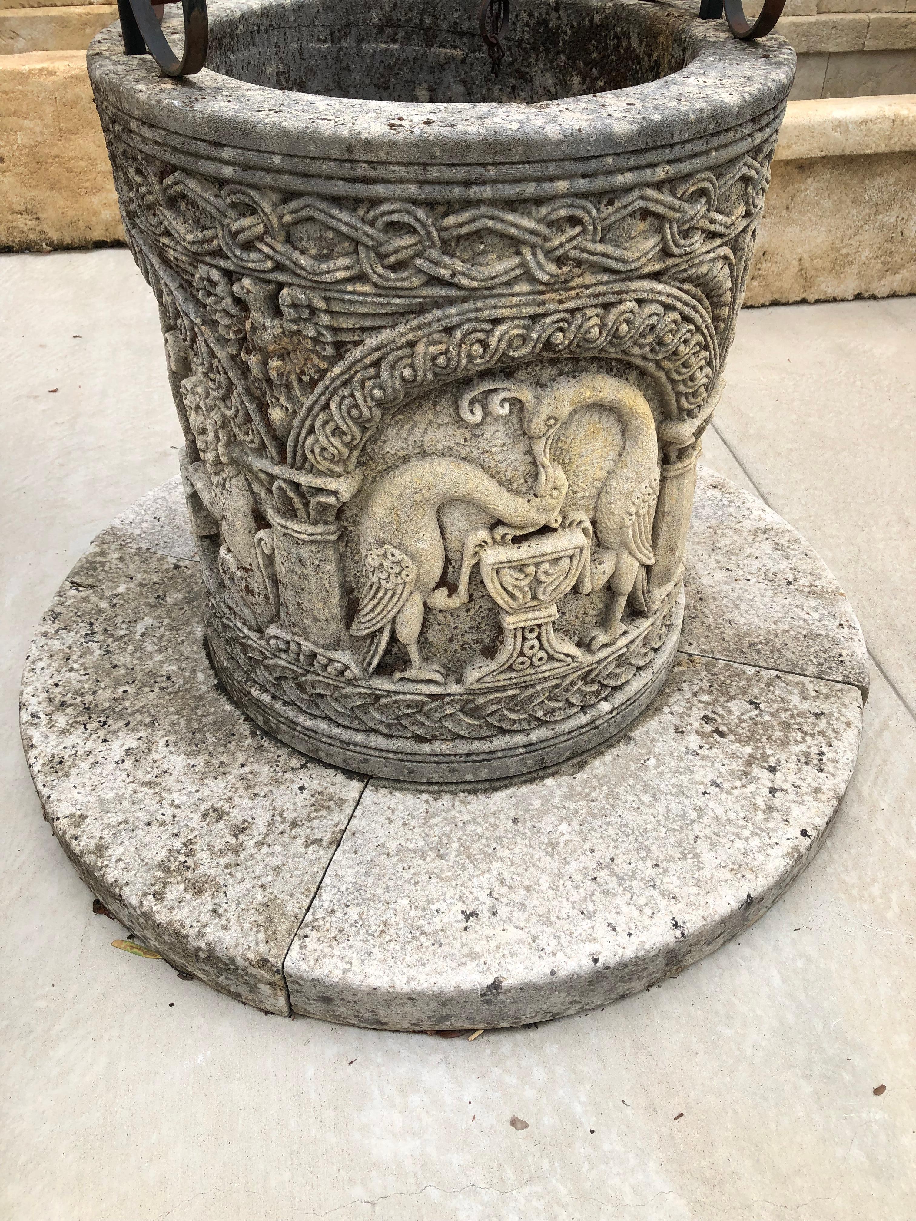 Hand-carved in the middle Byzantine style (which corresponds to Western Europe’s Medieval period), this highly detailed wellhead from Italy has a large, elaborate iron overthrow that rises over five feet above the top of the well. The overthrow